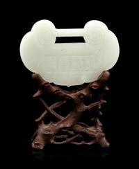 A White Jade Lock-Form Pendant with Stand