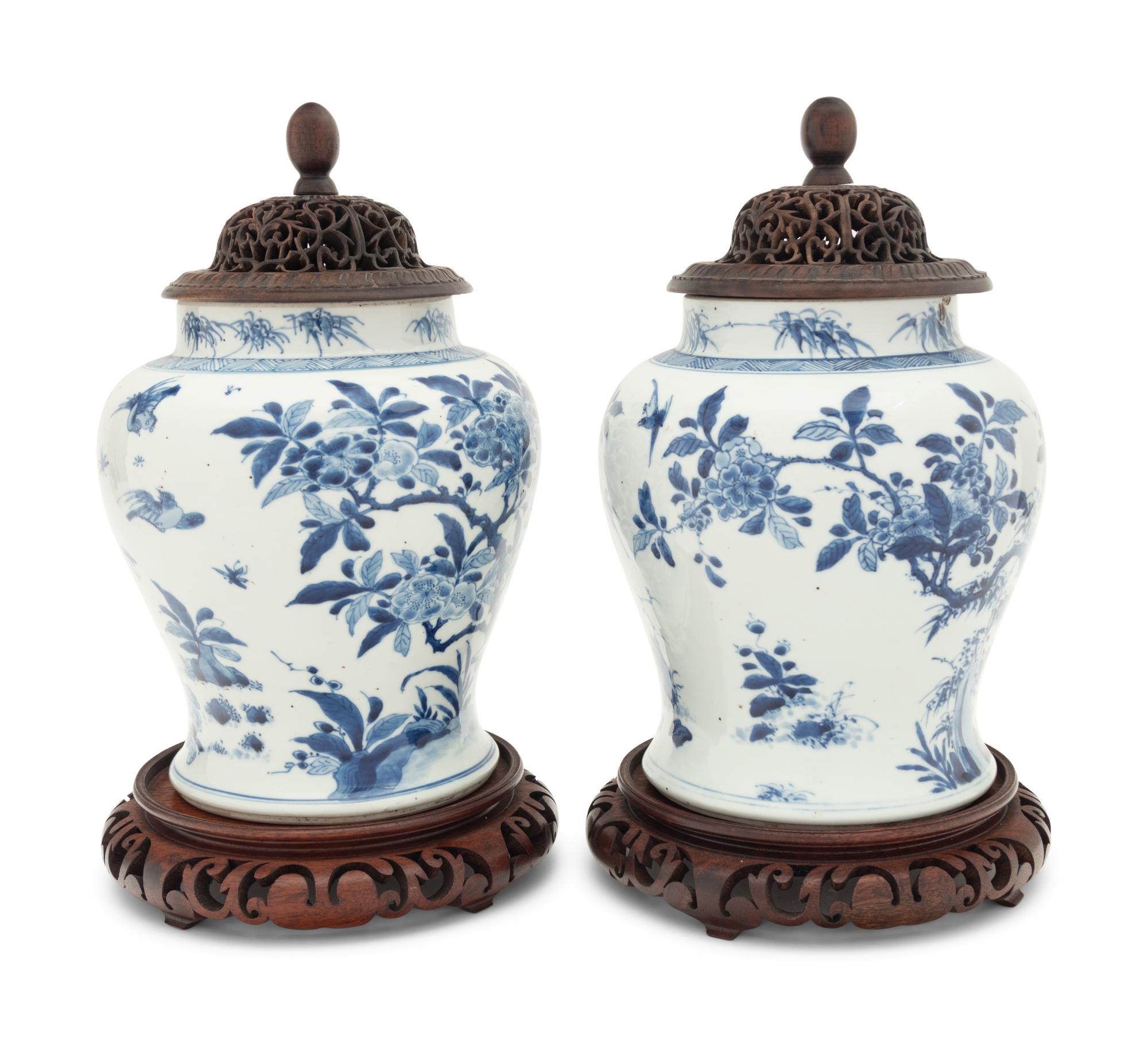 A Pair of Chinese Blue and White Porcelain Ginger Jars with Pierced Wood Lids and Stands