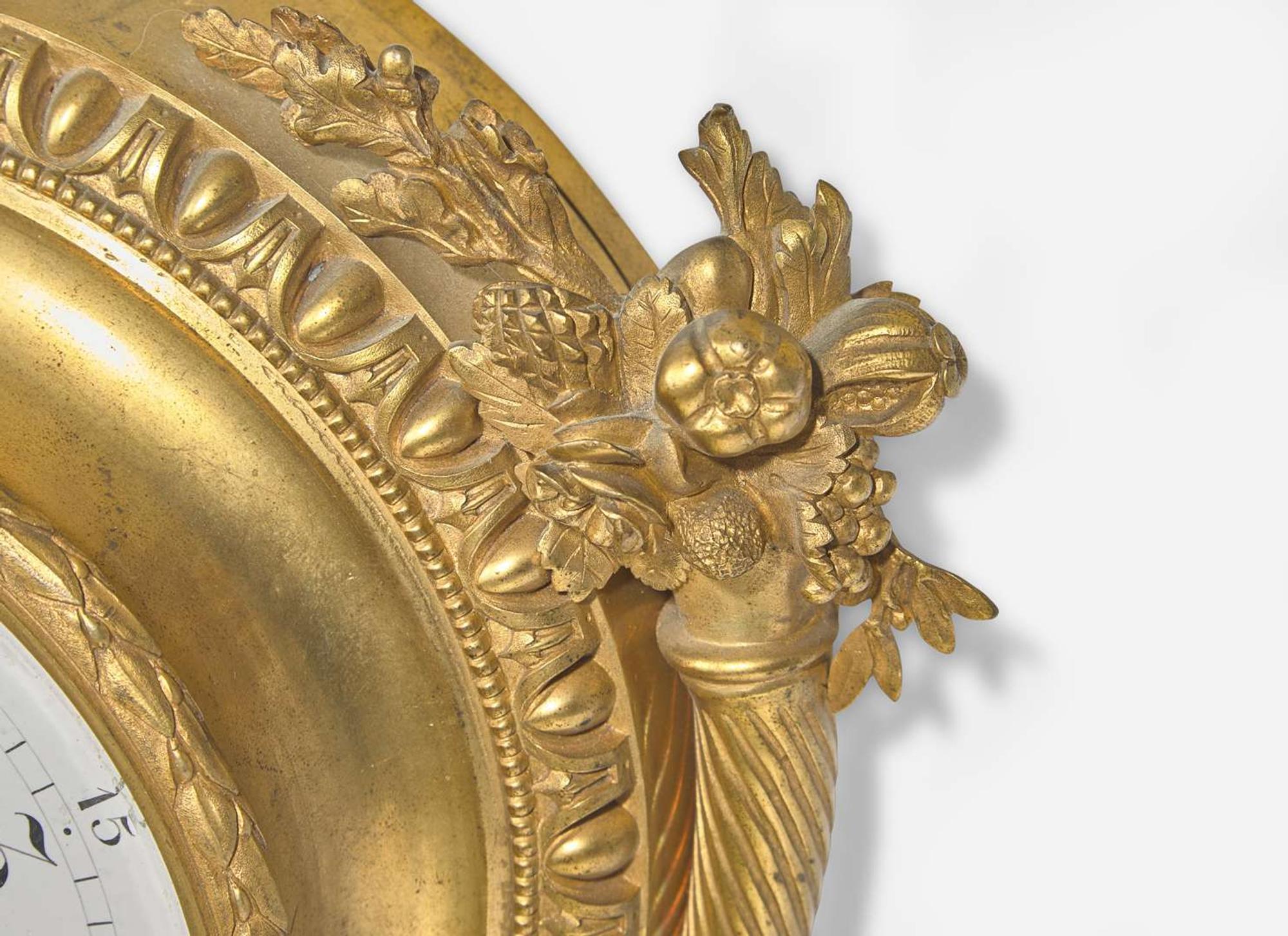 A Louis XVI Style Gilt Bronze and Enameled Porcelain Cartel Clock
