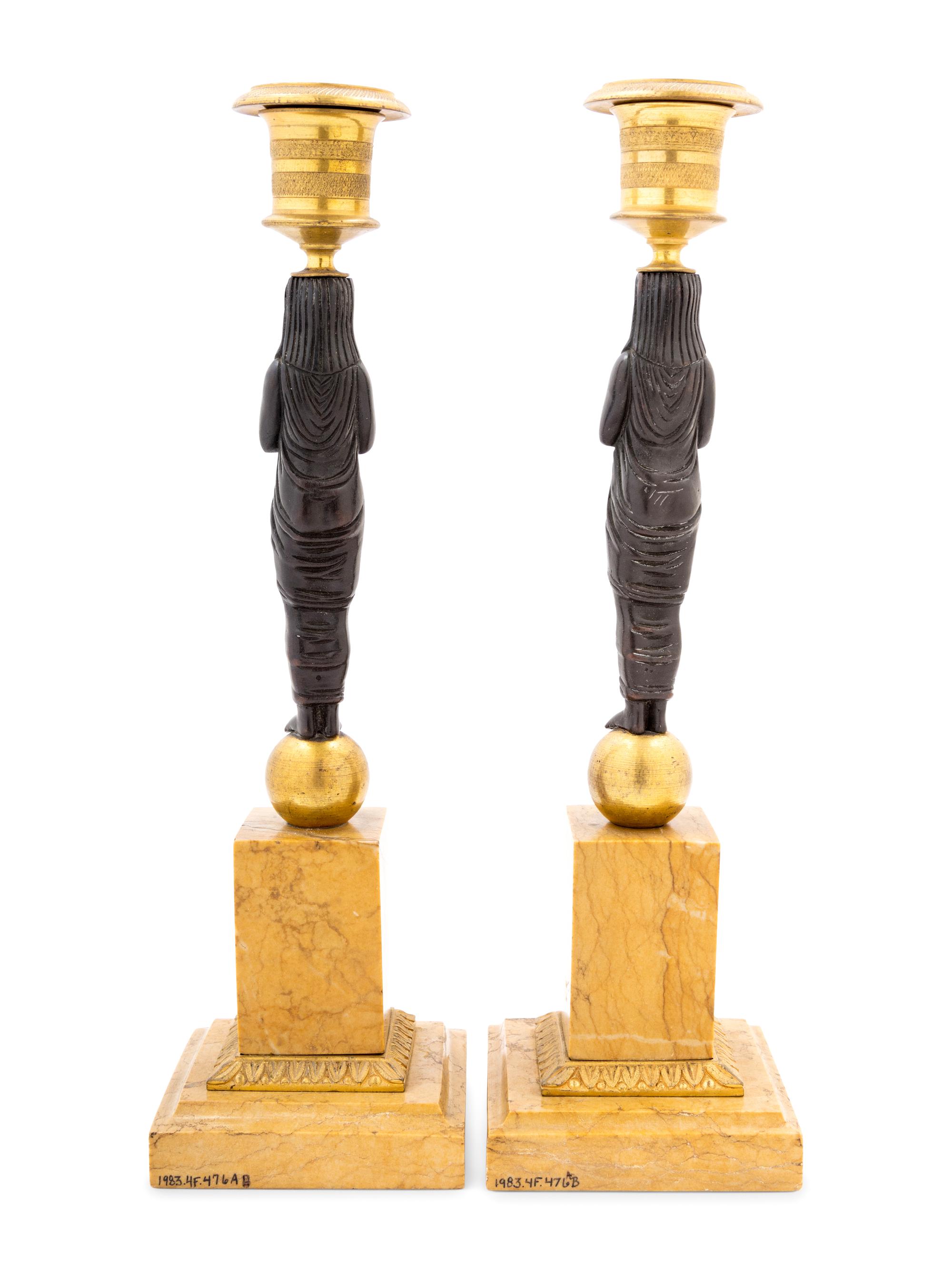 A Pair of French Egyptian Revival Bronze and Marble Candlesticks