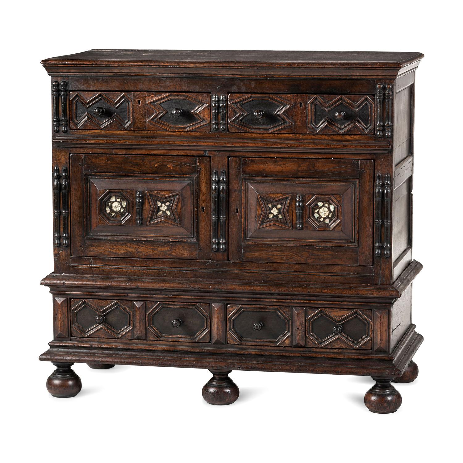 A Flemish Paneled and Molded Oak Chest of Drawers