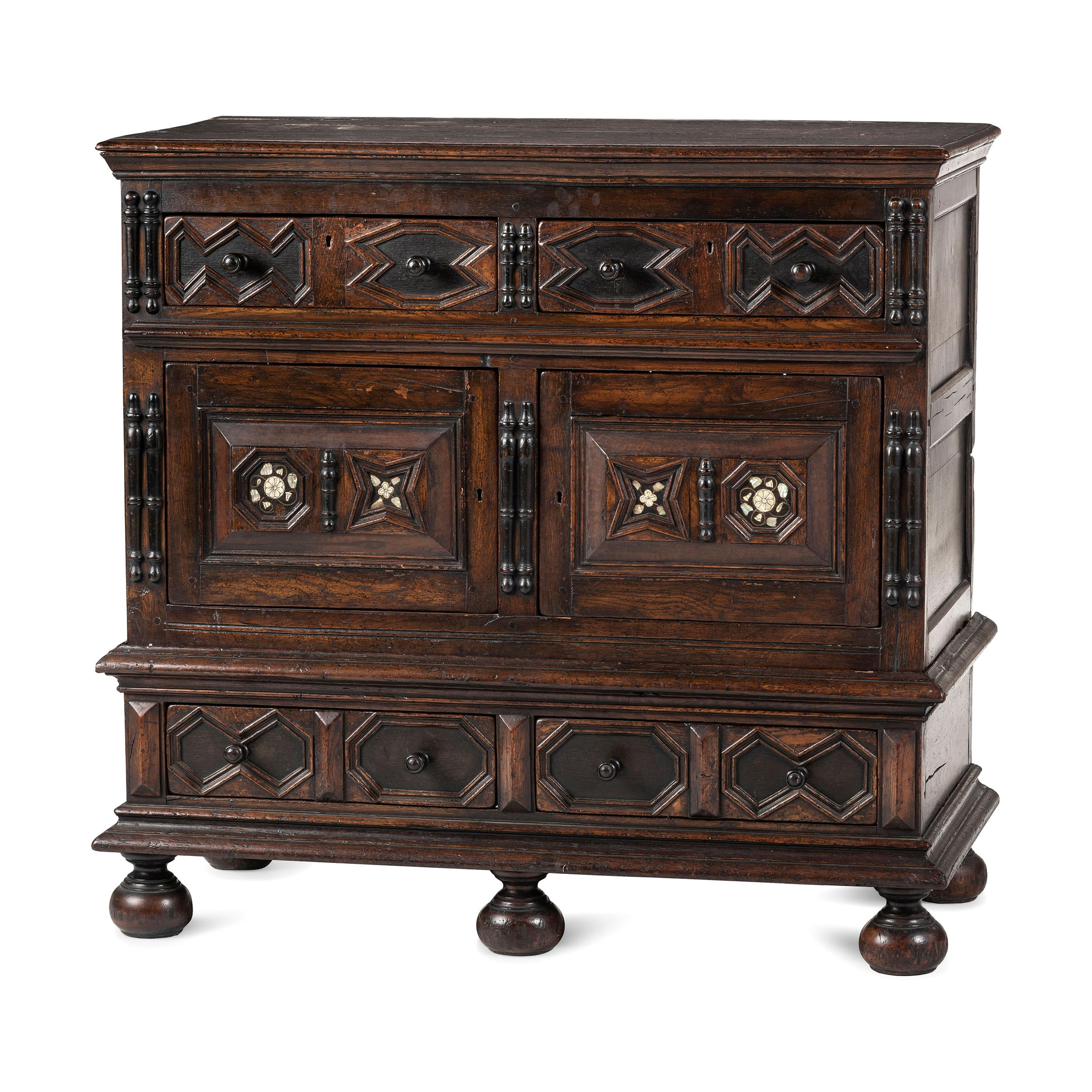 A Flemish Paneled and Molded Oak Chest of Drawers