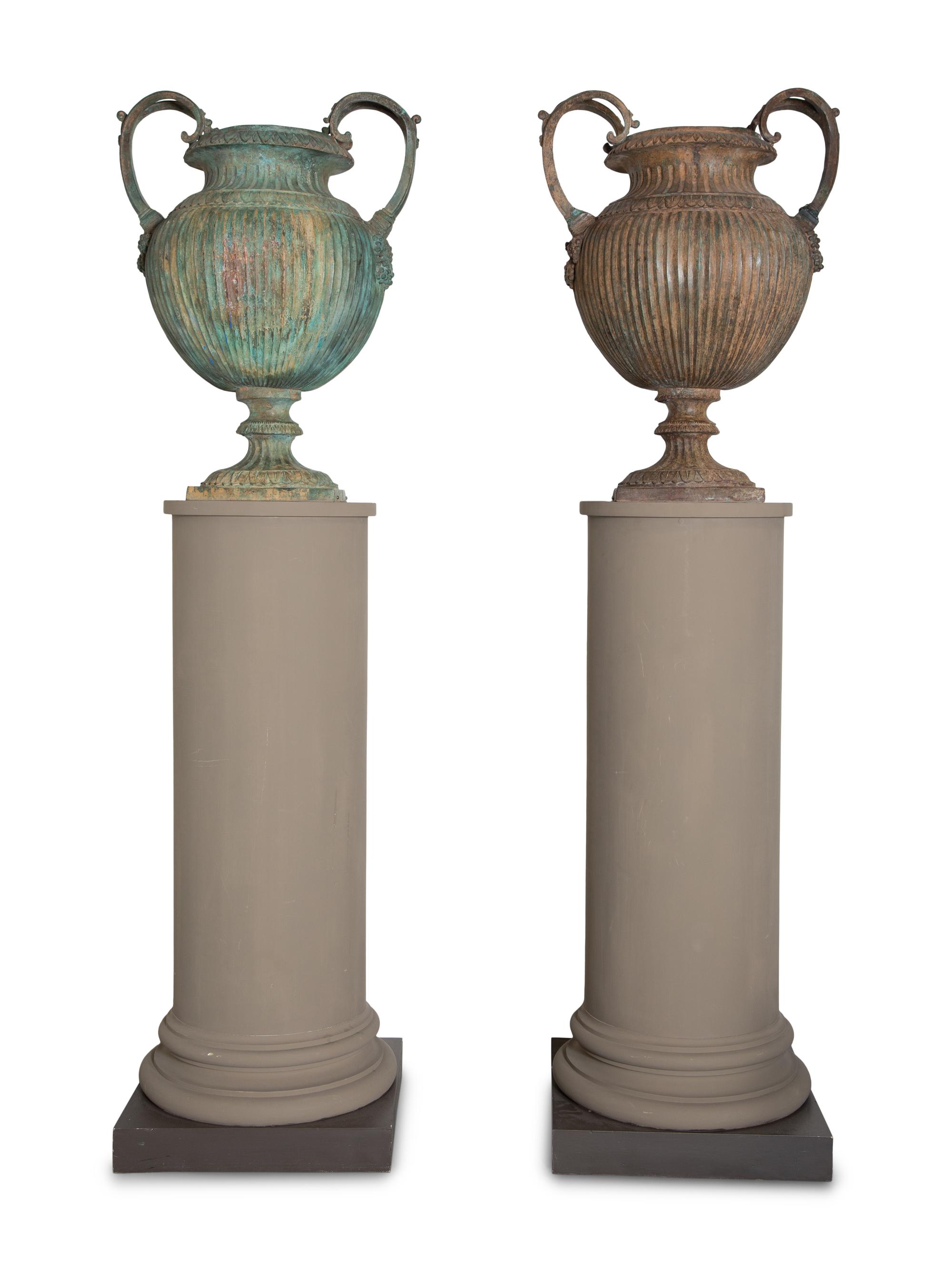 A Pair of Neoclassical Patinated Cast Metal Urns on Gray-Painted Wood Pedestals