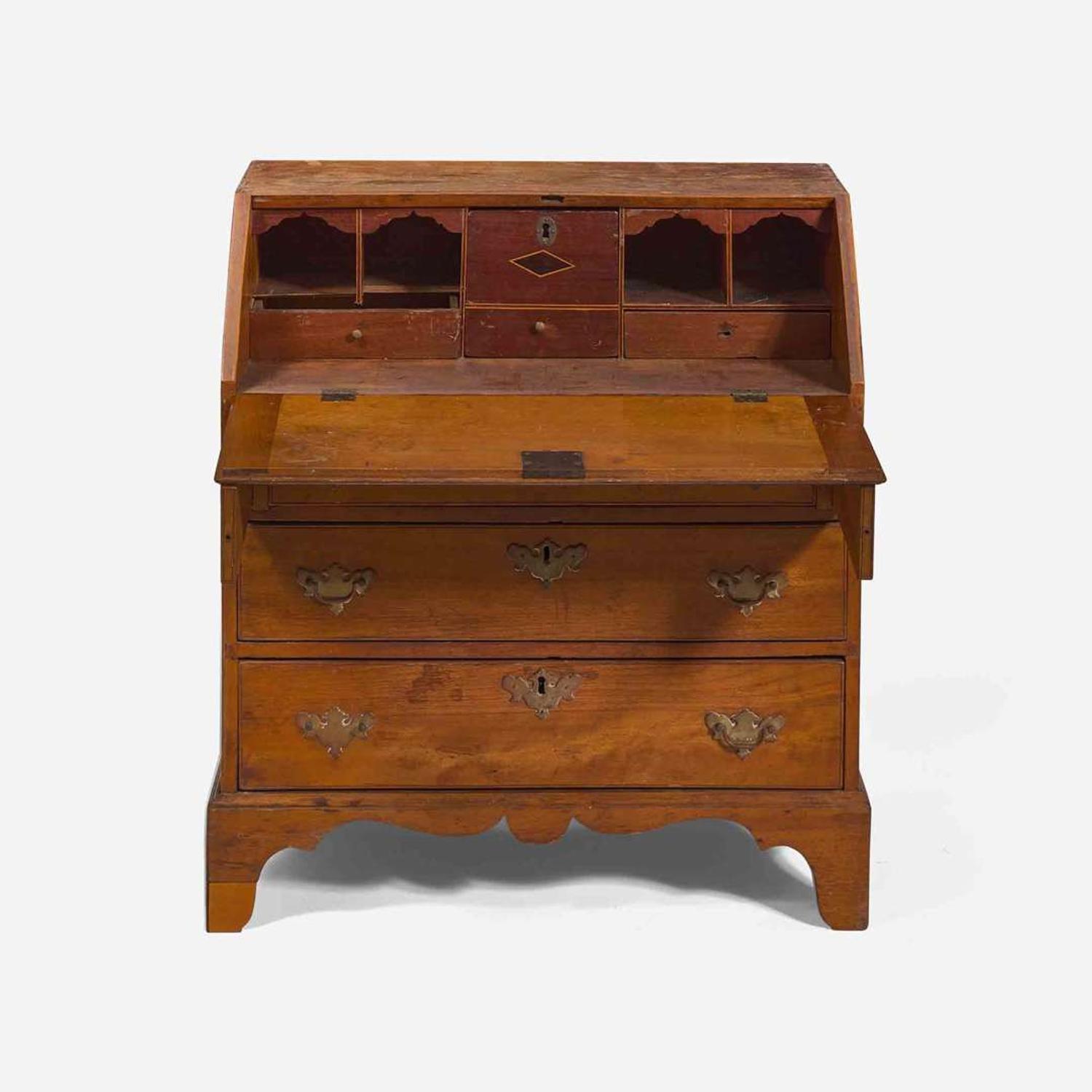 A Federal child's cherry slant-front desk together with a needlework sampler late 18th / early 19th century