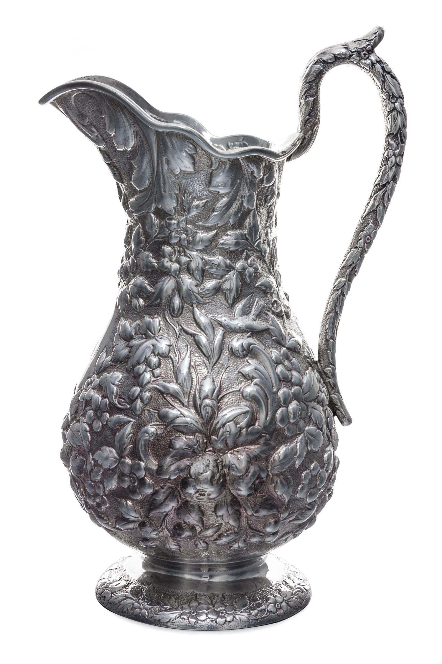 An American Silver Pitcher, Andrew Ellicott Warner, Baltimore, MD, 19th Century, having floral and foliate repousse decoration on a sti