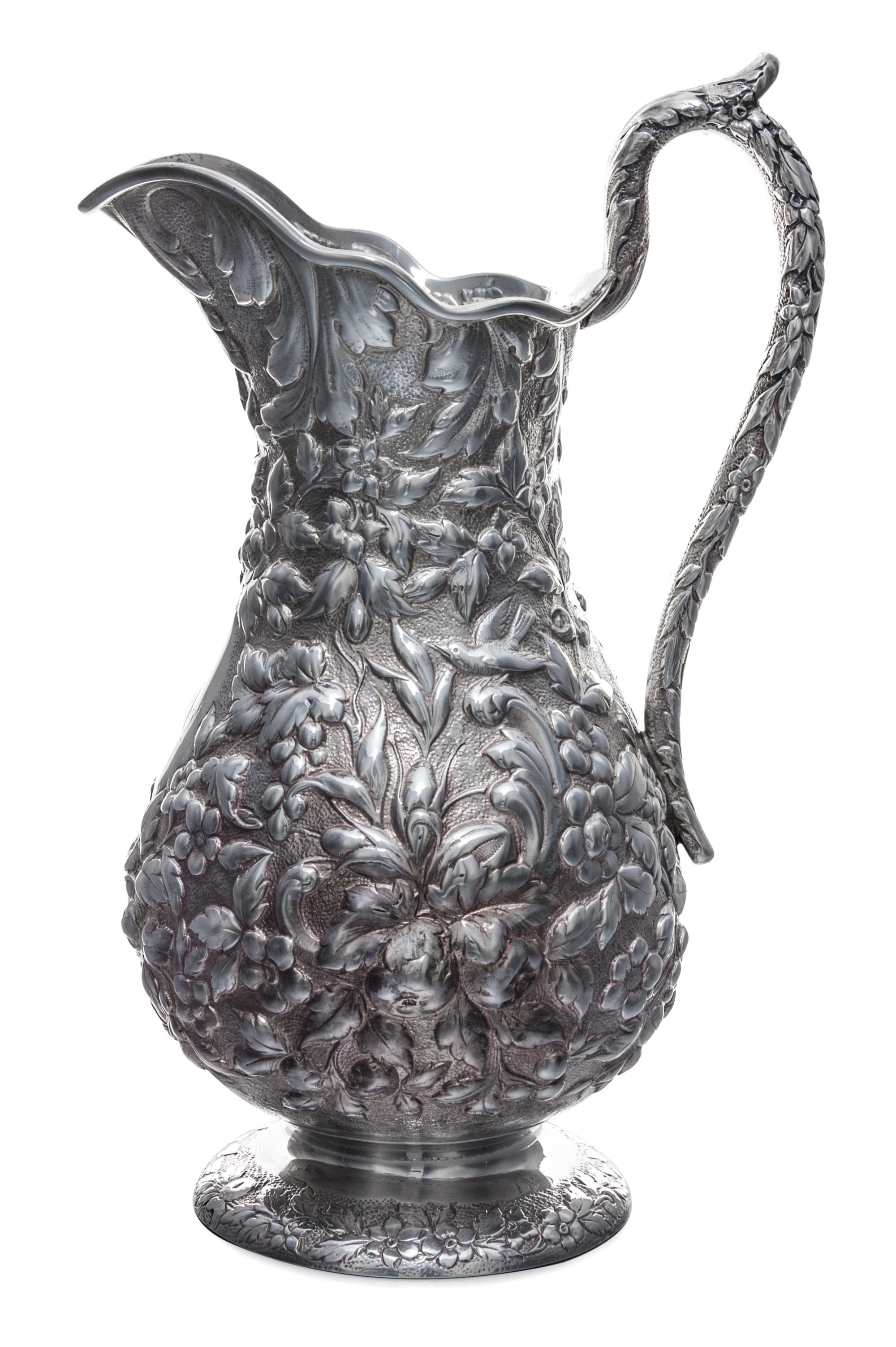 An American Silver Pitcher, Andrew Ellicott Warner, Baltimore, MD, 19th Century, having floral and foliate repousse decoration on a sti