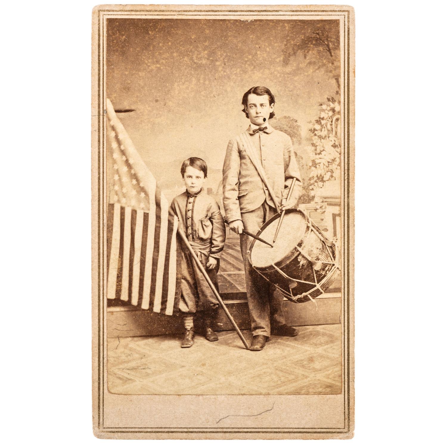 COLLINS, T.P., photographer. Patriotic Civil War CDV of brothers Oliver and Frederick Hutchinson with flag and eagle drum. Westfield, MA: [1860s].