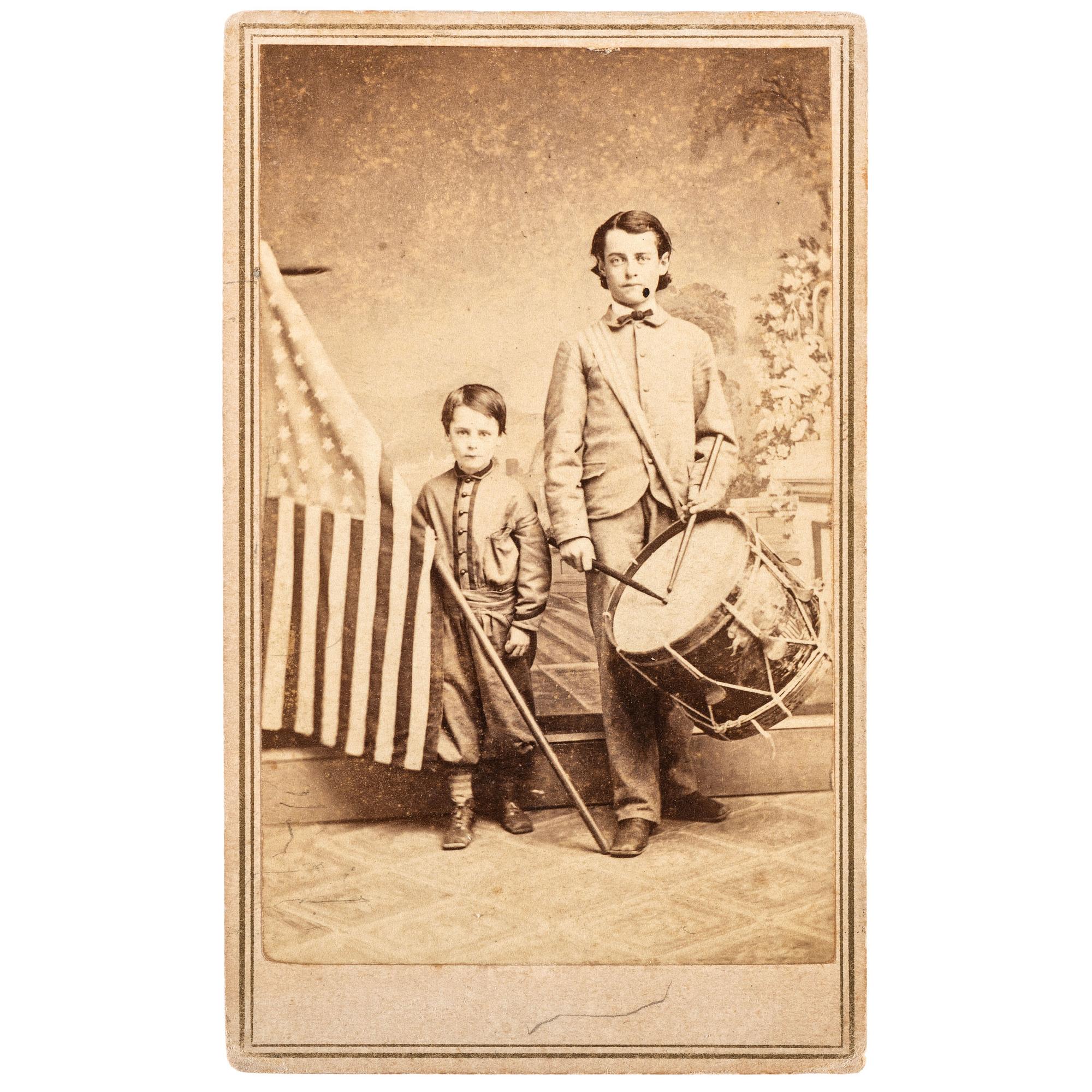 COLLINS, T.P., photographer. Patriotic Civil War CDV of brothers Oliver and Frederick Hutchinson with flag and eagle drum. Westfield, MA: [1860s].