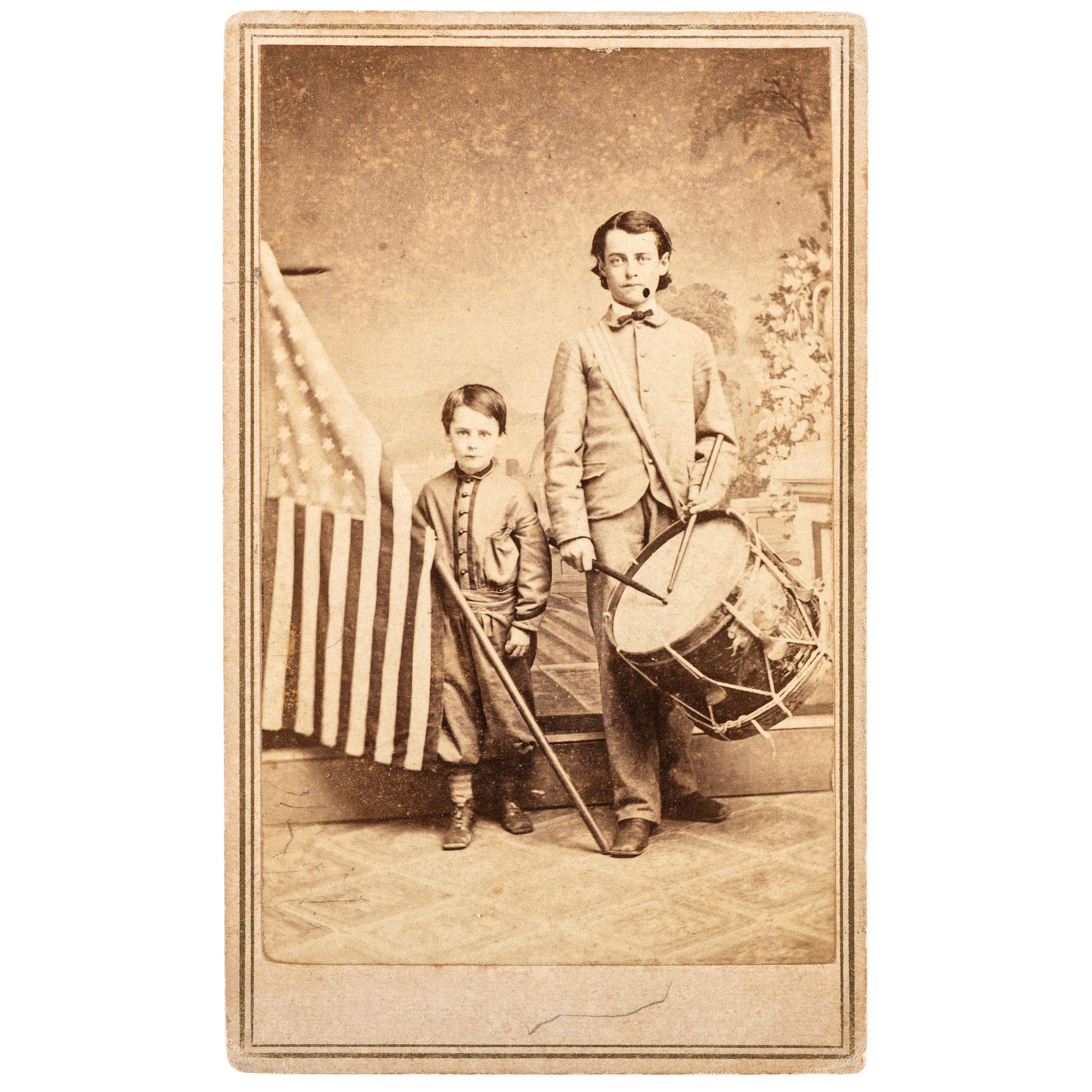 COLLINS, T.P., photographer. Patriotic Civil War CDV of brothers Oliver and Frederick Hutchinson with flag and eagle drum. Westfield, MA: [1860s].