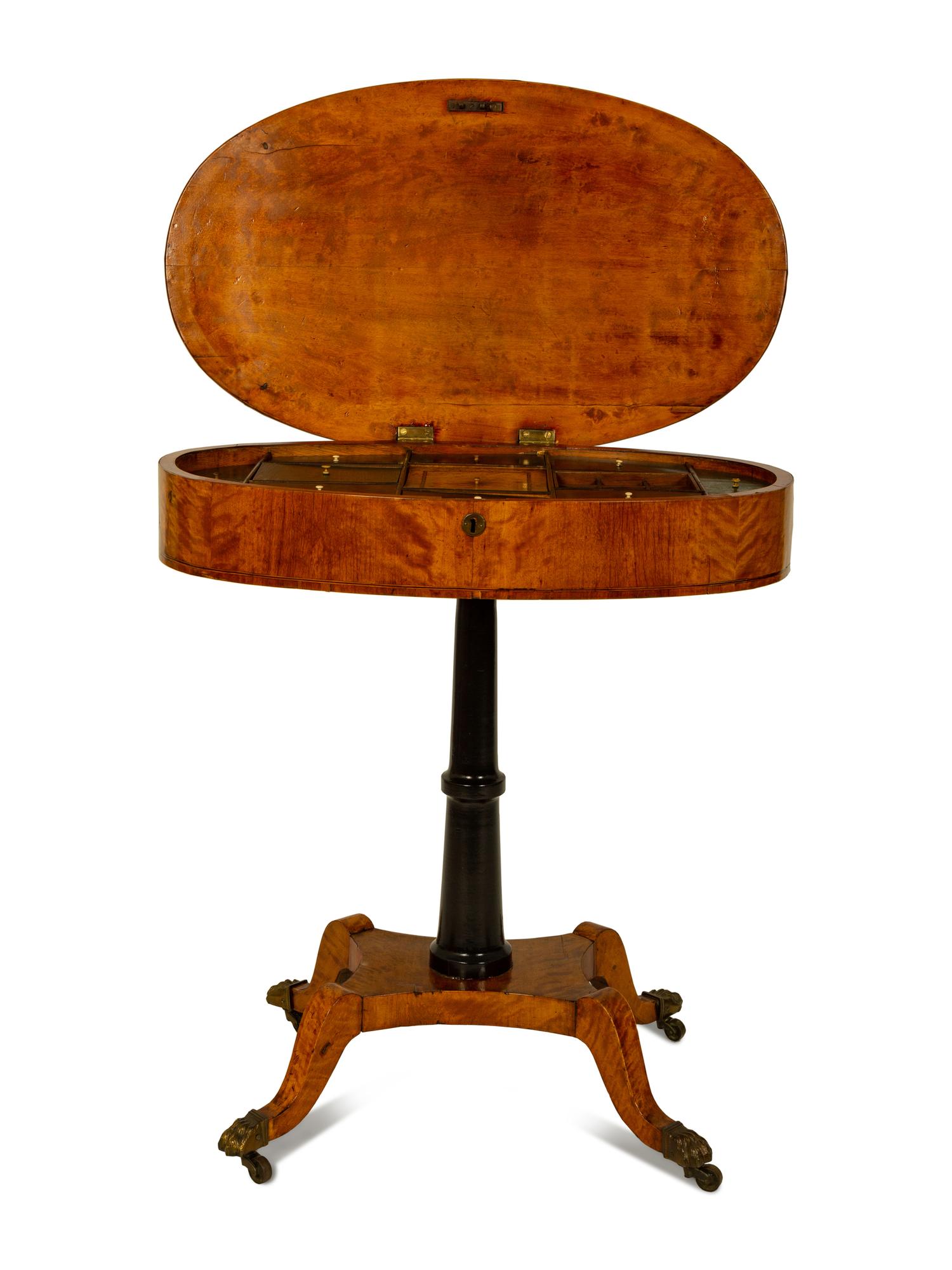 A Regency Inlaid Satinwood, Ebonized and Parcel Gilt Oval Work Table — EARLY 19TH CENTURY