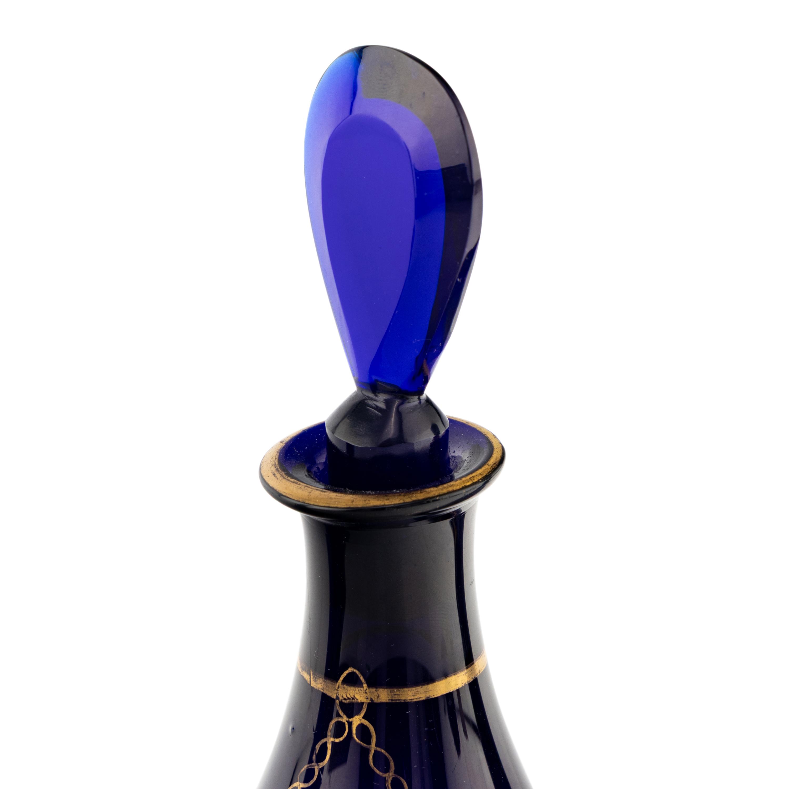 A Group of Four Cobalt Glass and Gilt Decorated Decanters