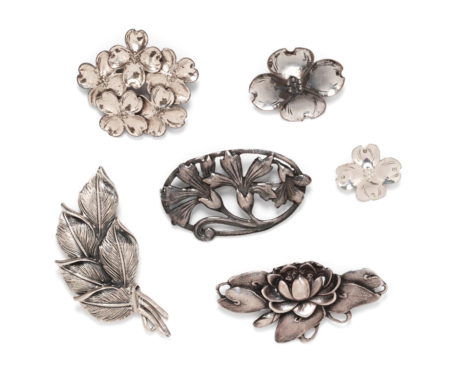 A Collection of Sterling Silver Floral Motif Brooches,