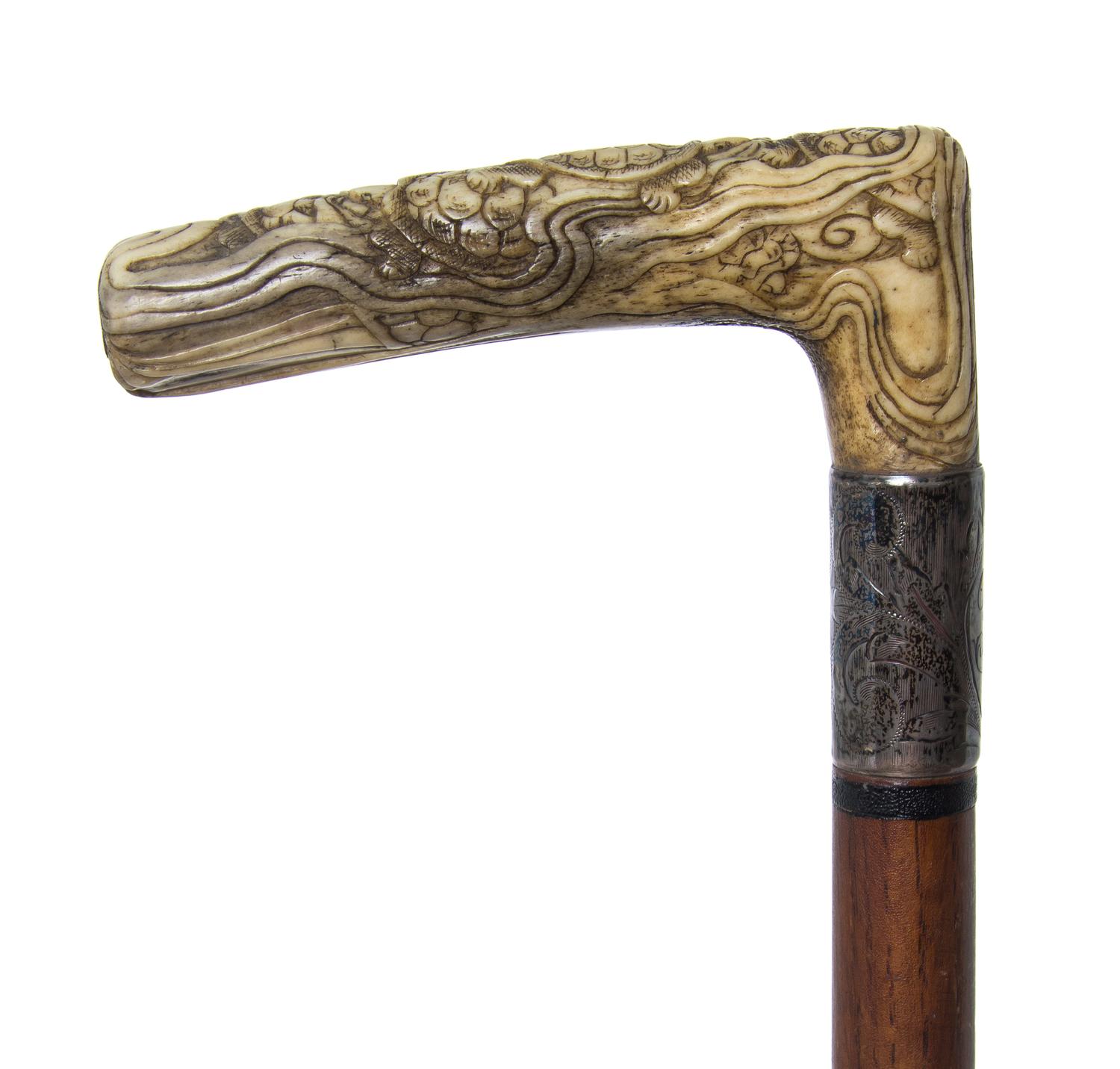 A Japanese Bone Handled Cane, Length of handle 4 1/2 x length overall 31 1/8 inches.