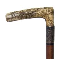 A Japanese Bone Handled Cane, Length of handle 4 1/2 x length overall 31 1/8 inches.
