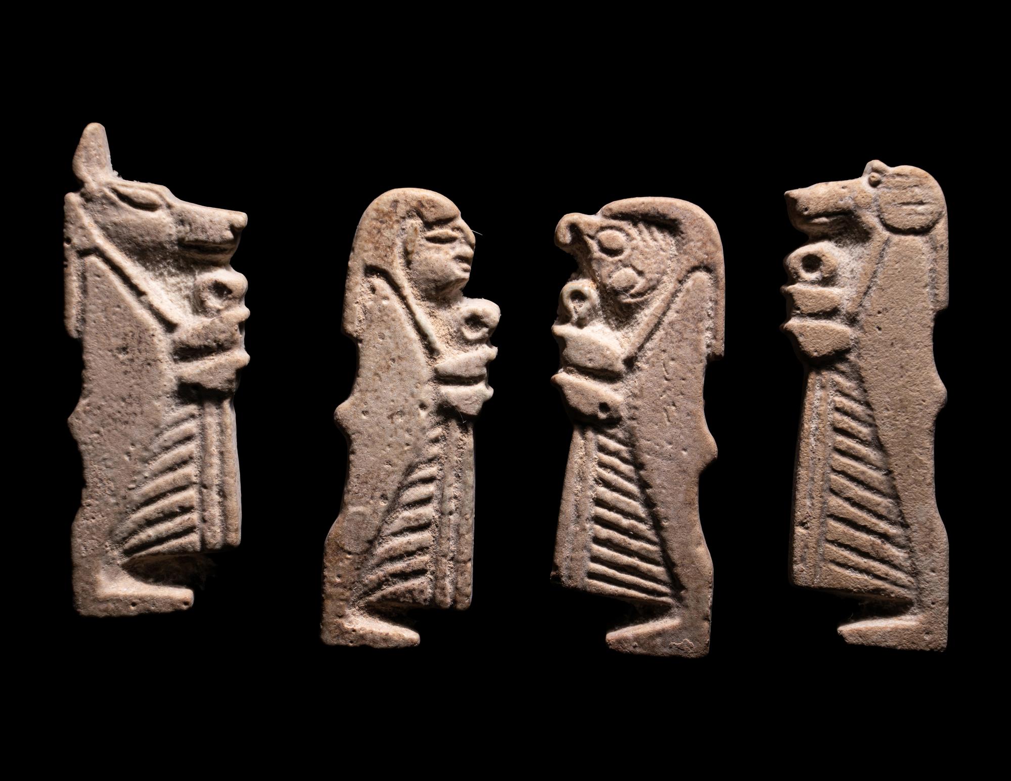A Set of Four Sons of Horus, Two Scarab Wings, and Two Heads of Horus as a Falcon
