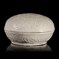 A Chinese Molded Dehua Porcelain Box and Cover, Song/Yuan Dynasty — 宋/元 德化白瓷卷草紋圓蓋盒