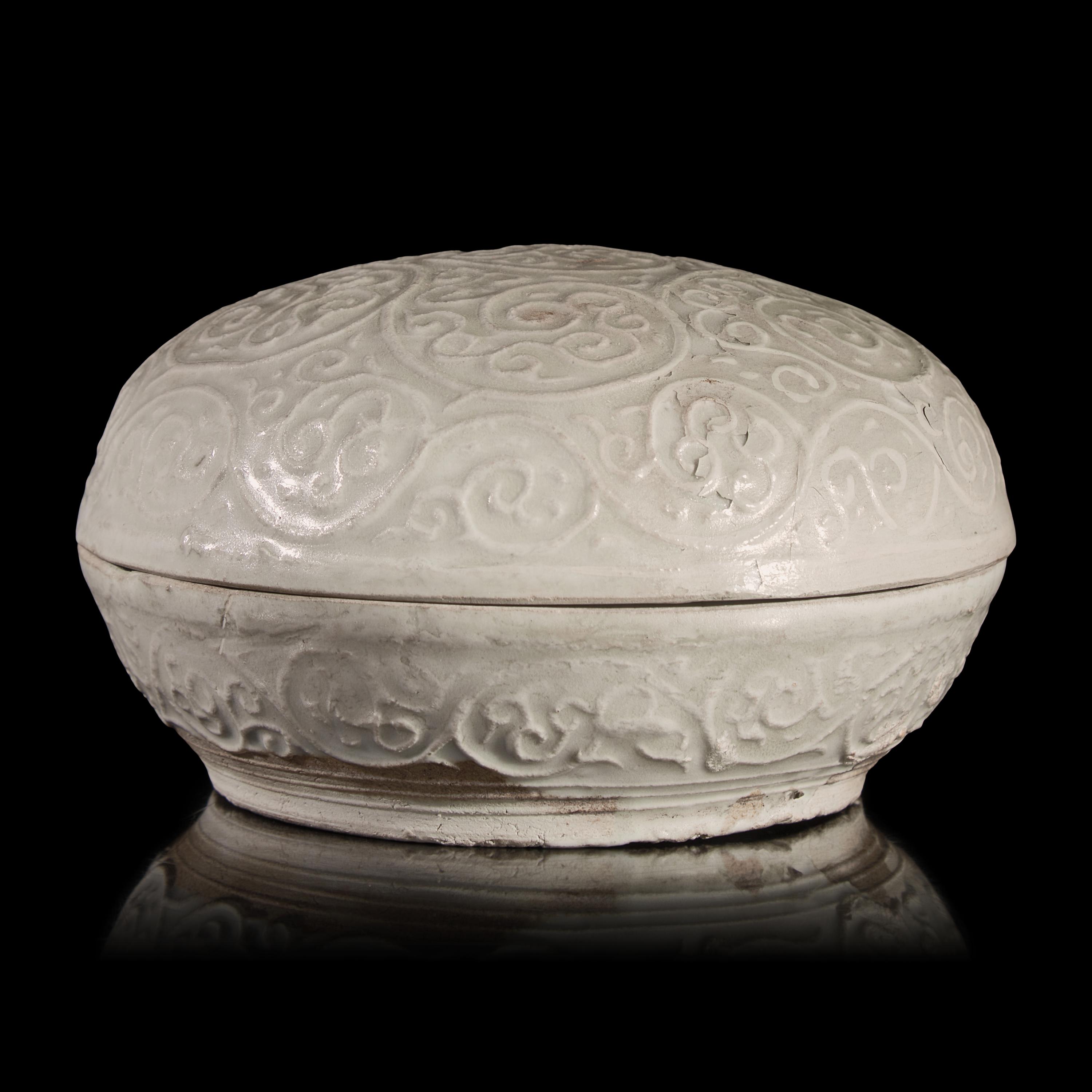 A Chinese Molded Dehua Porcelain Box and Cover, Song/Yuan Dynasty — 宋/元 德化白瓷卷草紋圓蓋盒