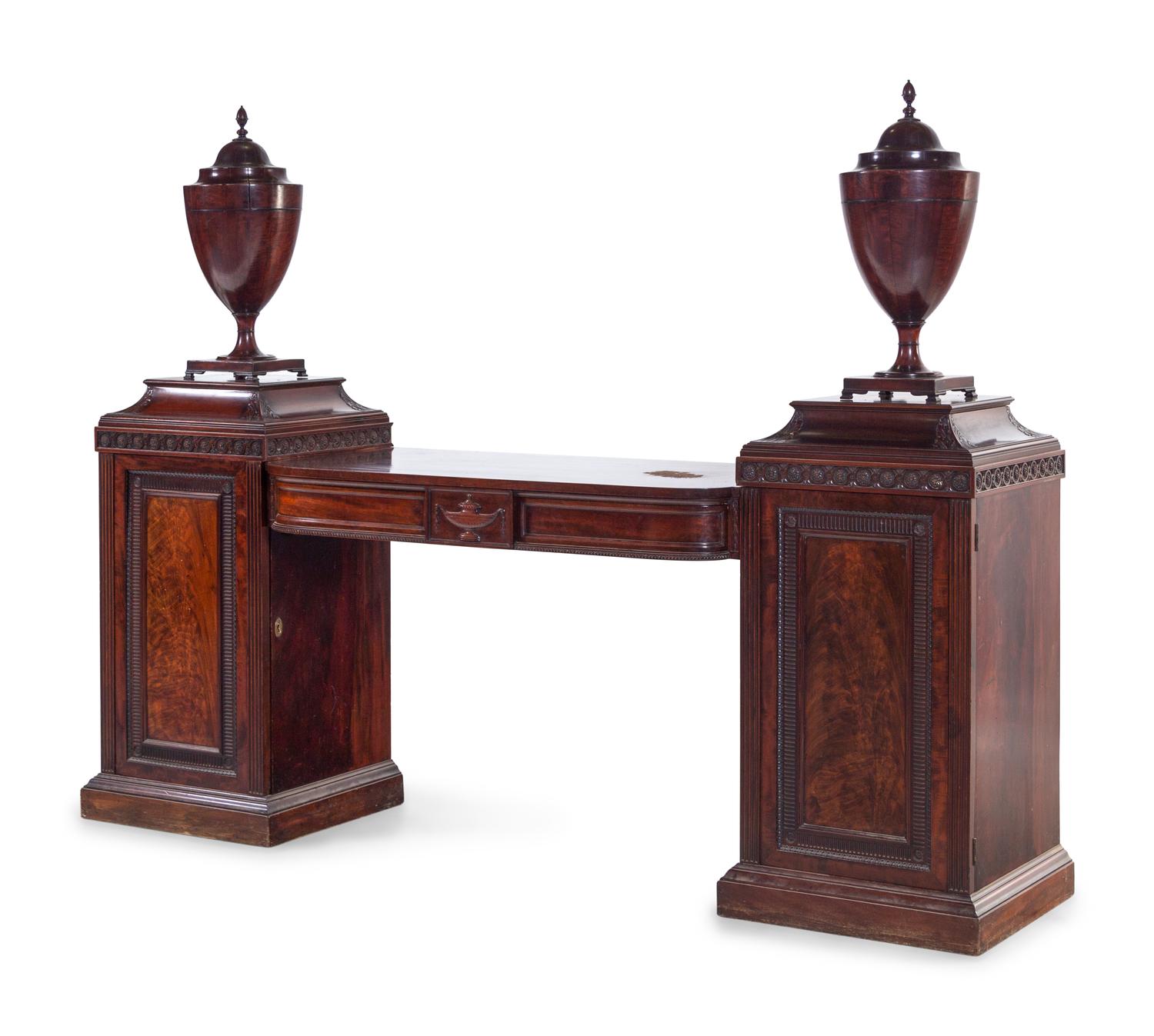 An Edwardian Carved and Figured Mahogany Double Pedestal Sideboard and a Pair of Urn-Form Cutlery Boxes