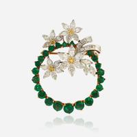 An emerald, diamond, colored diamond, gold, and platinum pendant/brooch