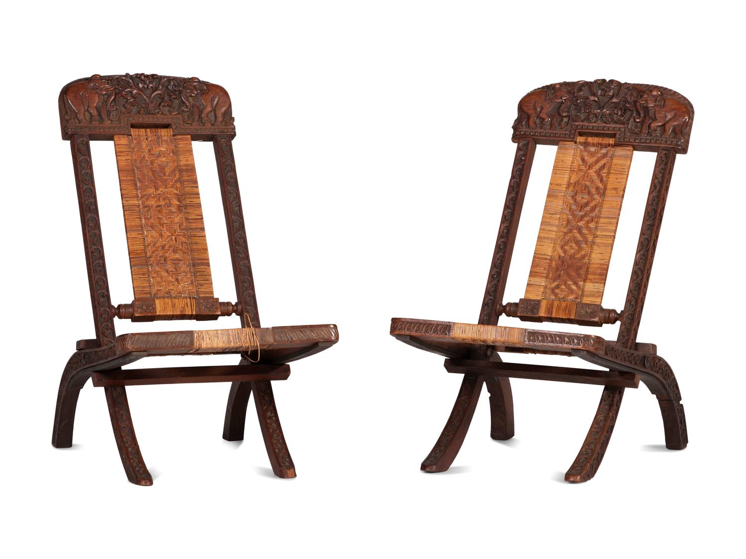 A Pair of Anglo-Indian Elephant-Carved Teak Cane Upholstered Folding Campaign Chairs