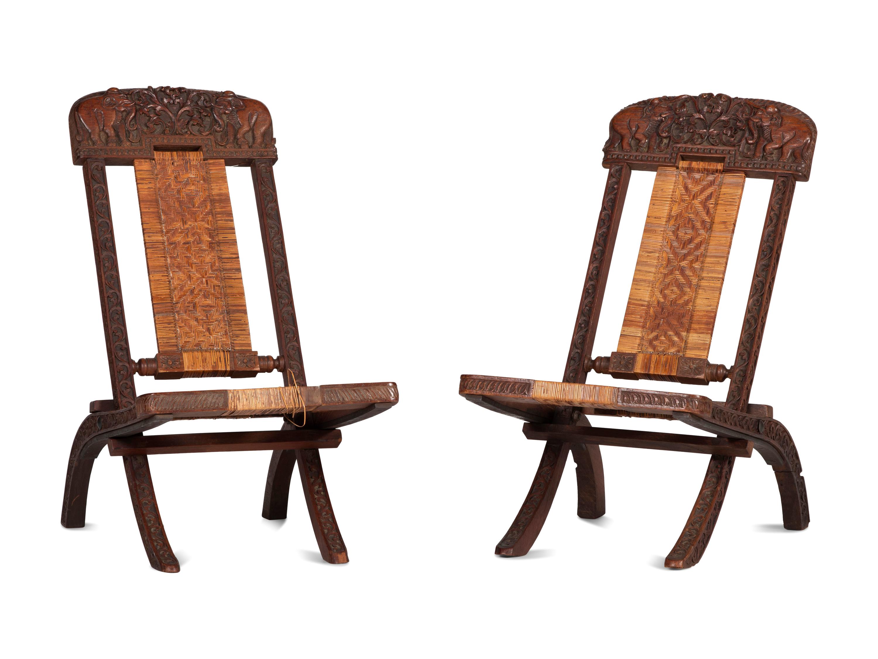 A Pair of Anglo-Indian Elephant-Carved Teak Cane Upholstered Folding Campaign Chairs