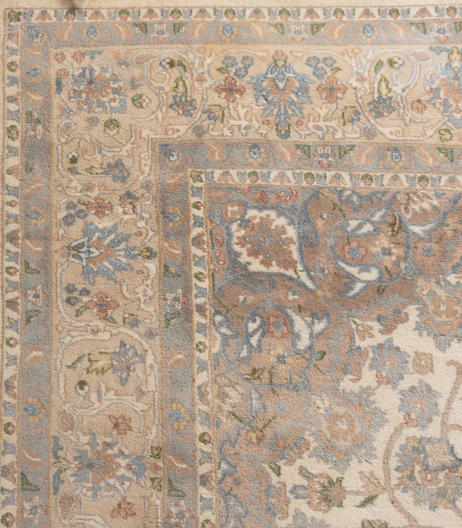 An Ivory and Pastel Rug