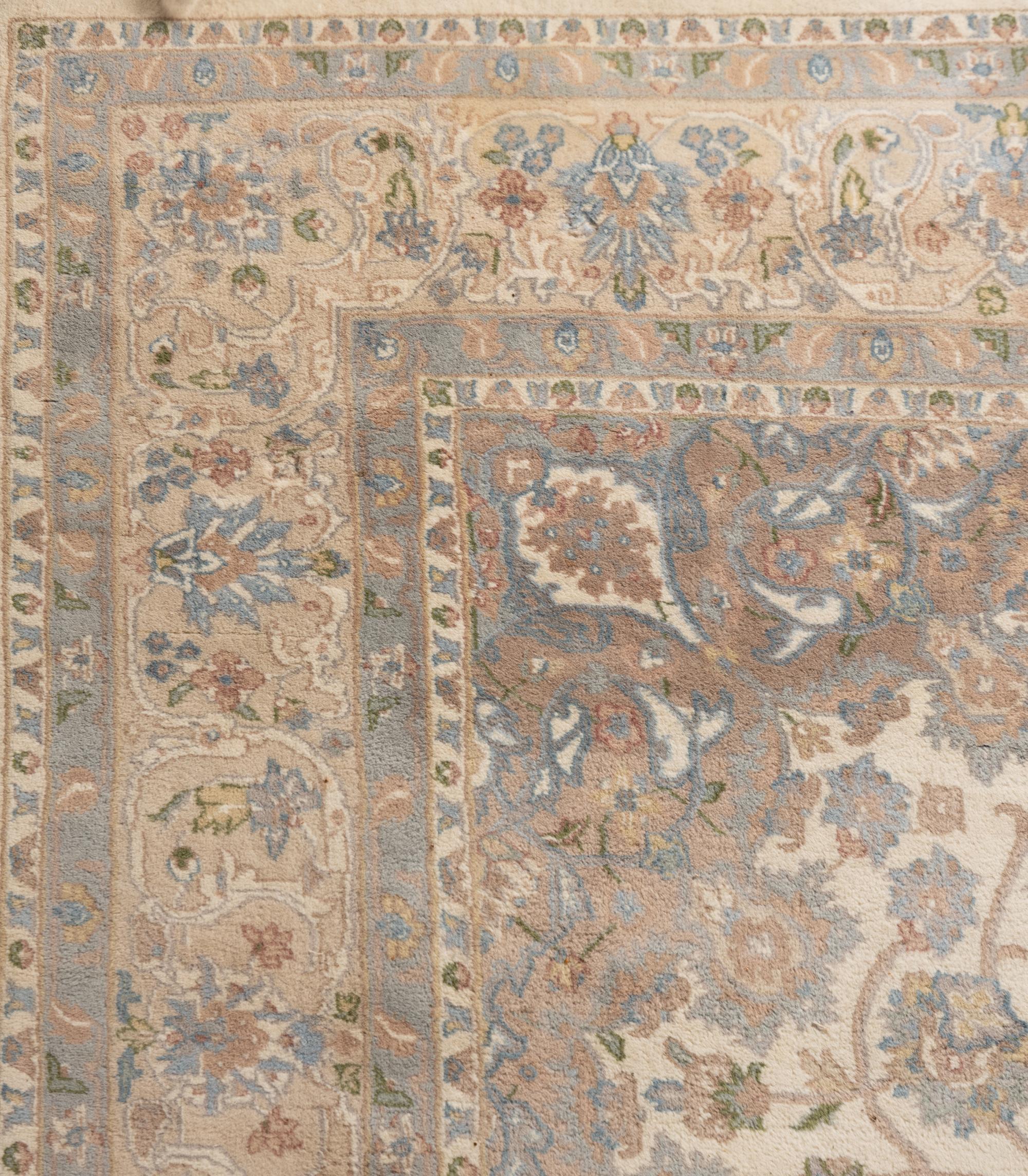 An Ivory and Pastel Rug