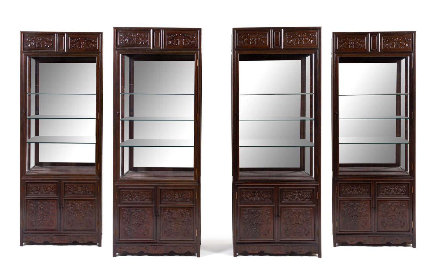 A Set of Four Chinese Zitan Veneer Hardwood Display Cabinets Height 85 x width 32 1/4 x depth 15 inches. — CABINET: 20TH CENTURY; CARVED PANELS: 19TH CENTURY