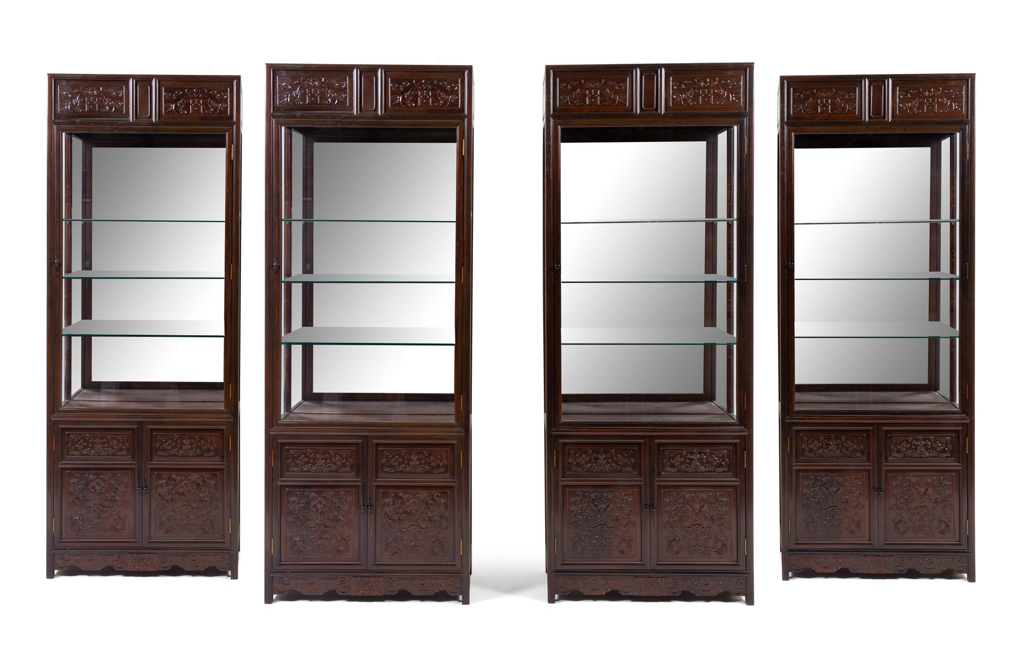 A Set of Four Chinese Zitan Veneer Hardwood Display Cabinets Height 85 x width 32 1/4 x depth 15 inches. — CABINET: 20TH CENTURY; CARVED PANELS: 19TH CENTURY