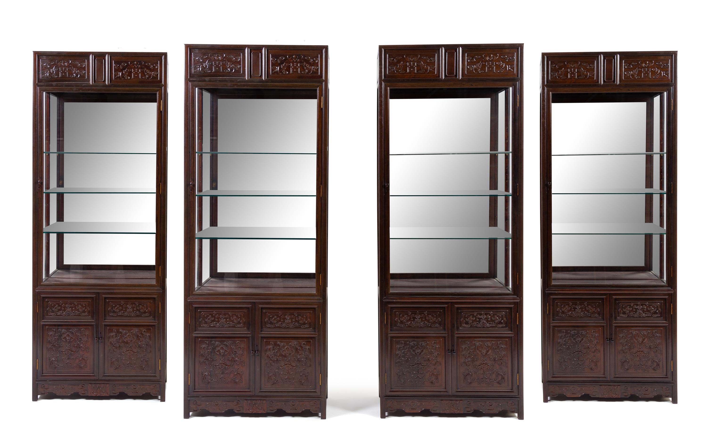 A Set of Four Chinese Zitan Veneer Hardwood Display Cabinets Height 85 x width 32 1/4 x depth 15 inches. — CABINET: 20TH CENTURY; CARVED PANELS: 19TH CENTURY