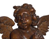 An Italian Baroque carved walnut angel, 17th century