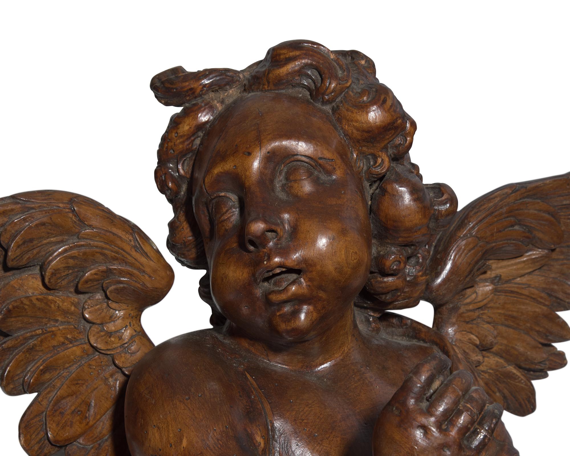 An Italian Baroque carved walnut angel, 17th century