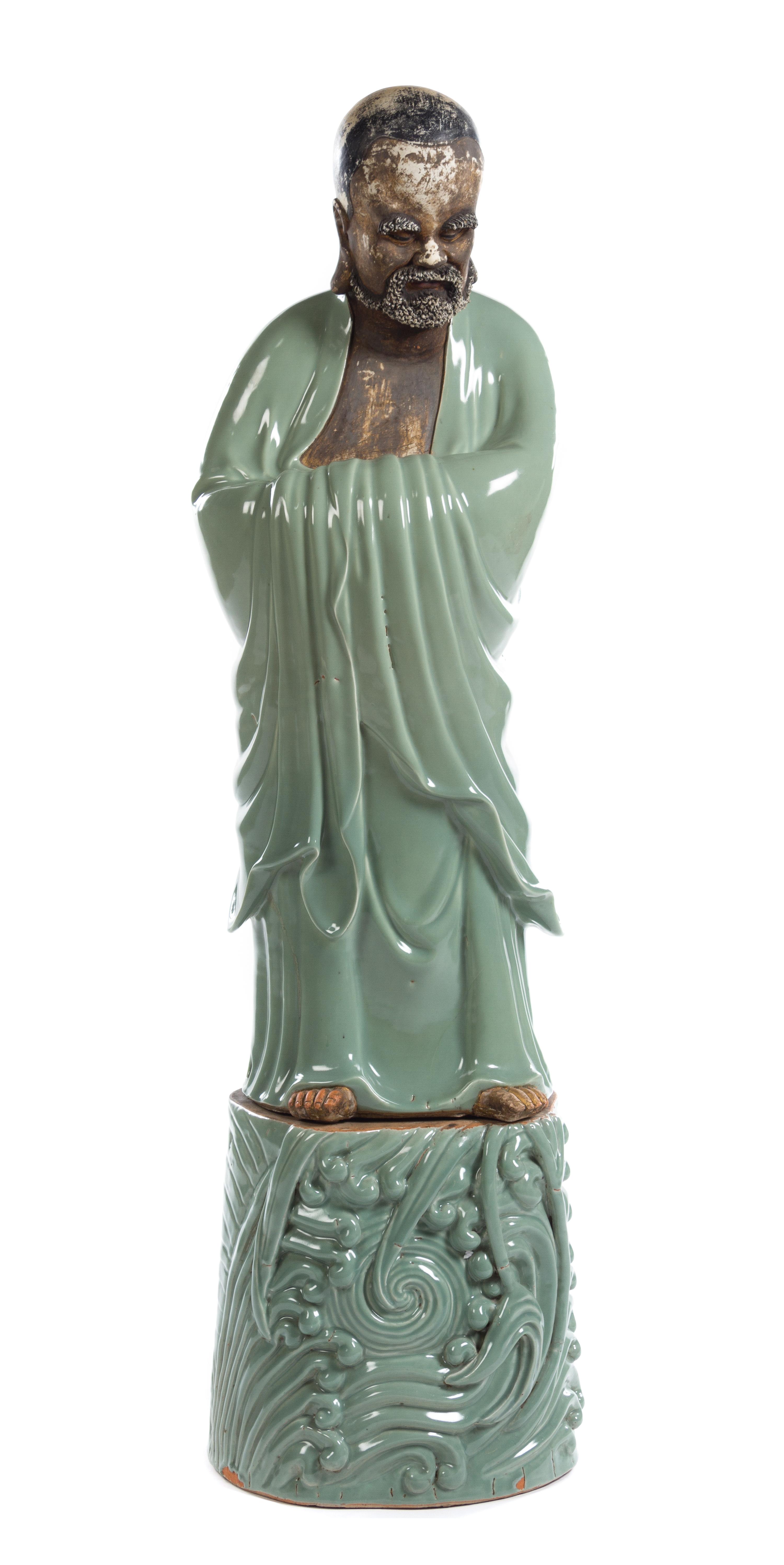 A Large and Rare Chinese Celadon Gazed Porcelain Standing Figure of Damo 18TH CENTURY OR EARLIER Height of figure 38 7/8 inches. — 18TH CENTURY OR EARLIER