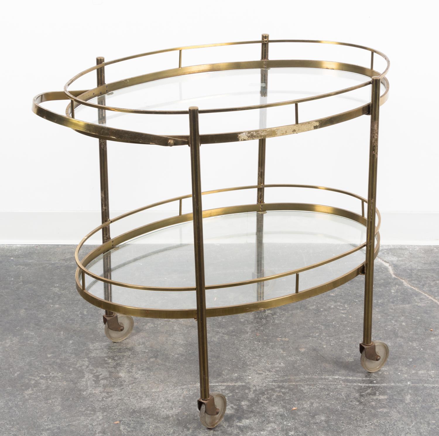An Art Deco Style Brass Bar Cart Height 28 x width over handle 33 x depth 19 1/4 inches.