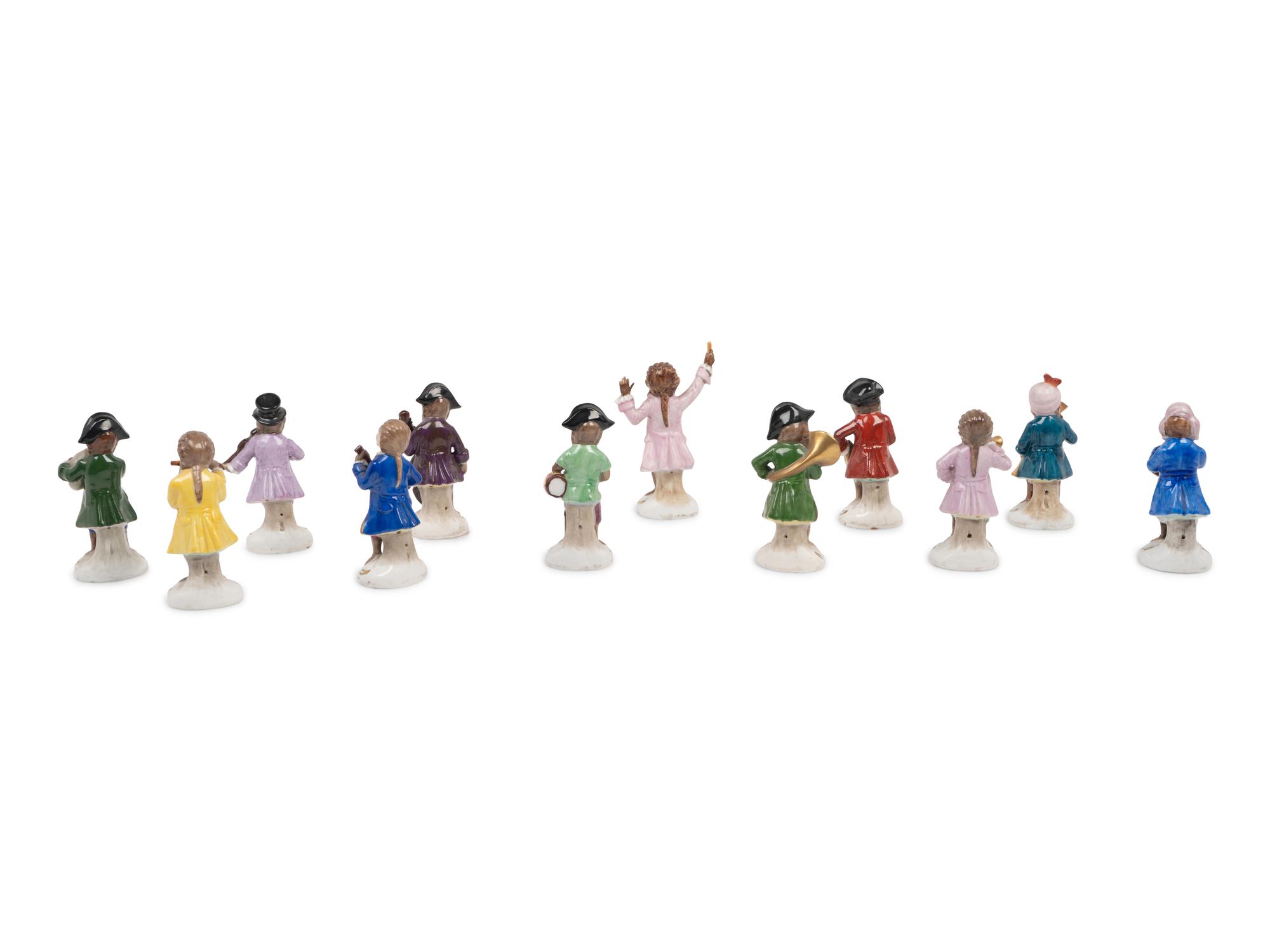 A German Porcelain Twelve-Piece Monkey Band