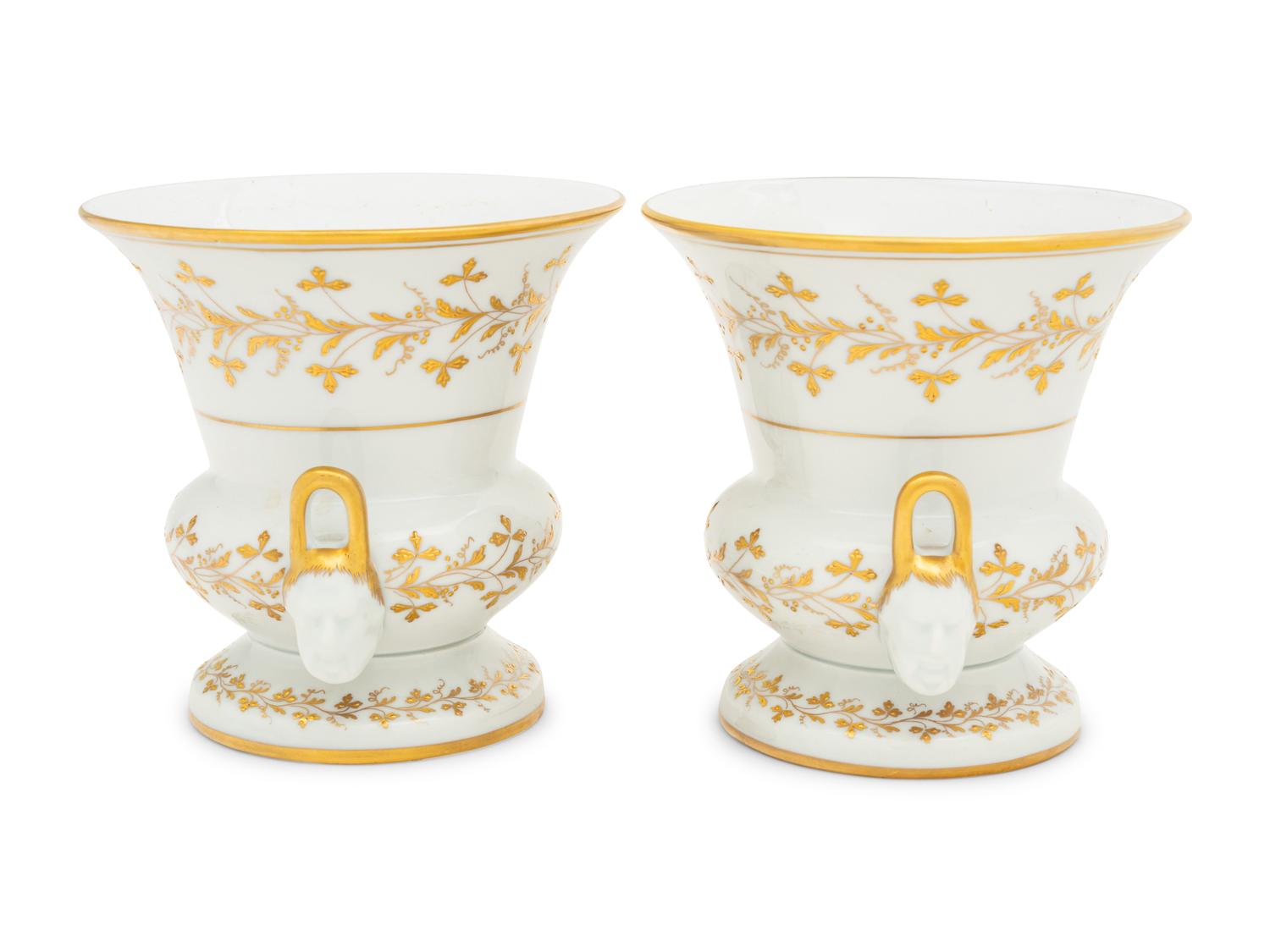 A Pair of French Parcel Gilt Porcelain Campagna Urns