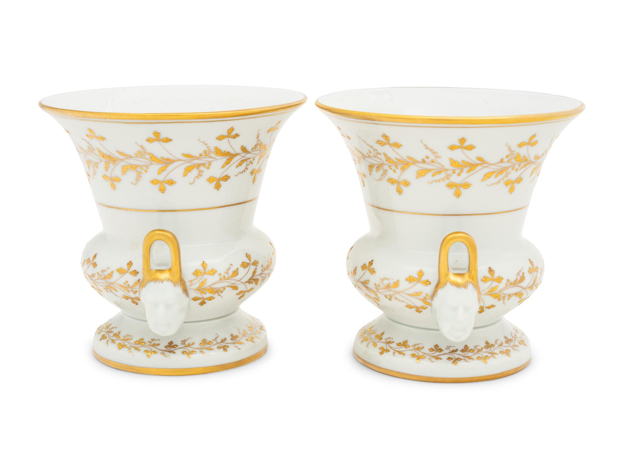 A Pair of French Parcel Gilt Porcelain Campagna Urns