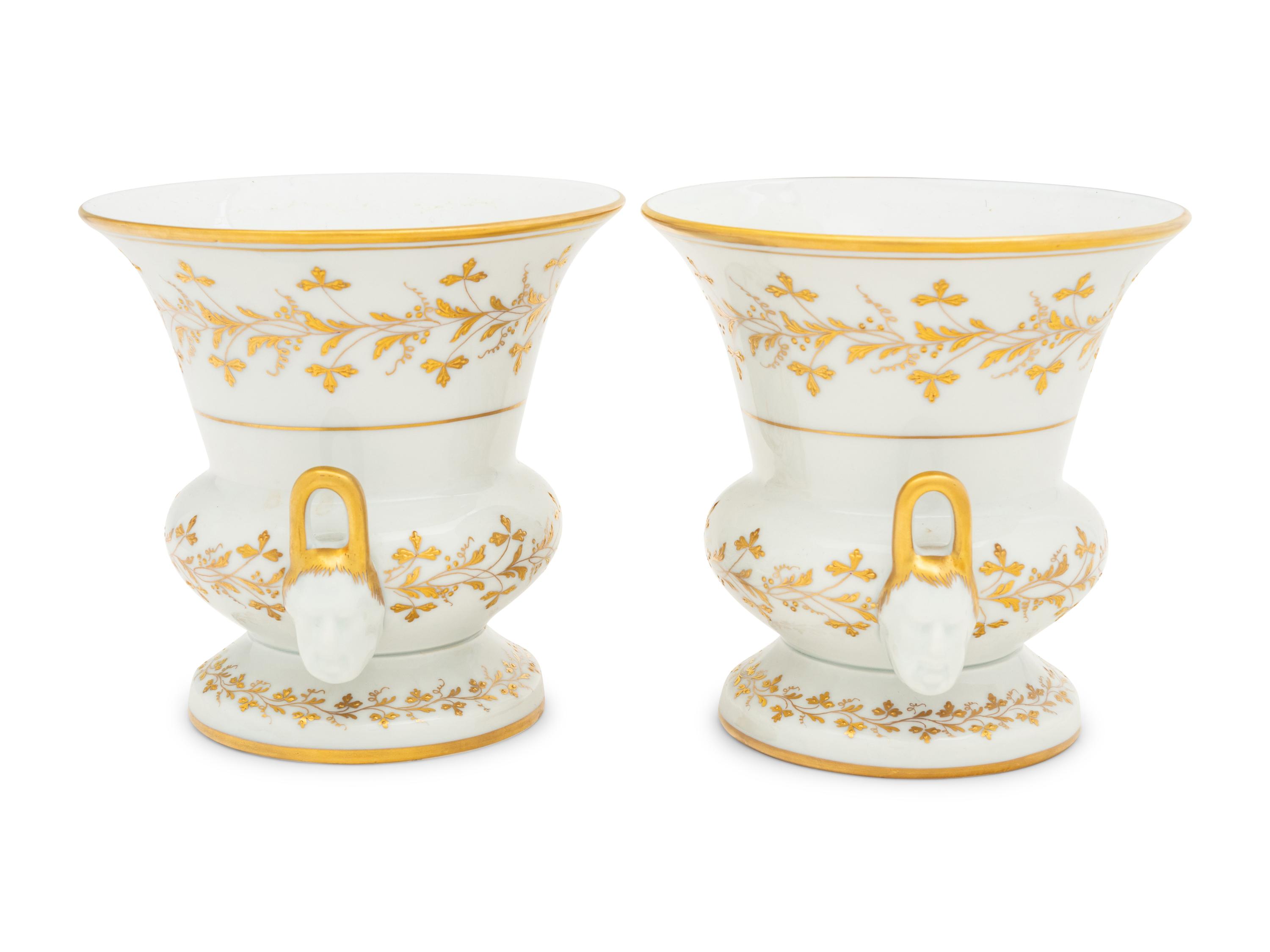 A Pair of French Parcel Gilt Porcelain Campagna Urns