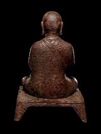 A Tibetan Cast Iron Figure of a Monk