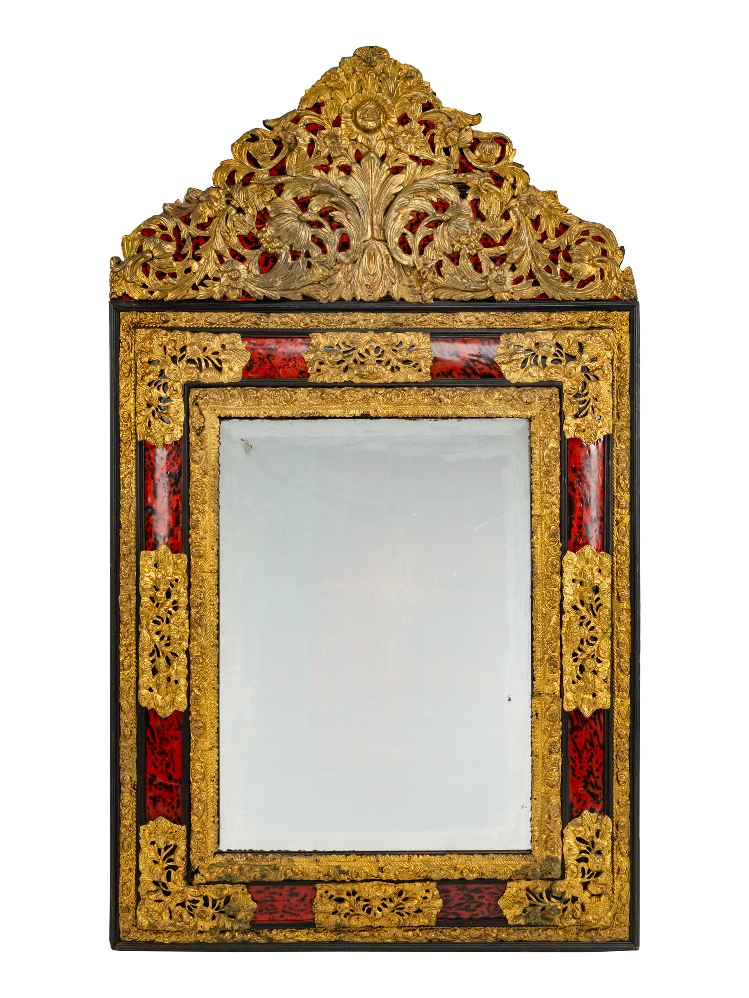 A Flemish Baroque Style Repouséed Brass, Simulated Tortoise and Ebonized Wood Mirror