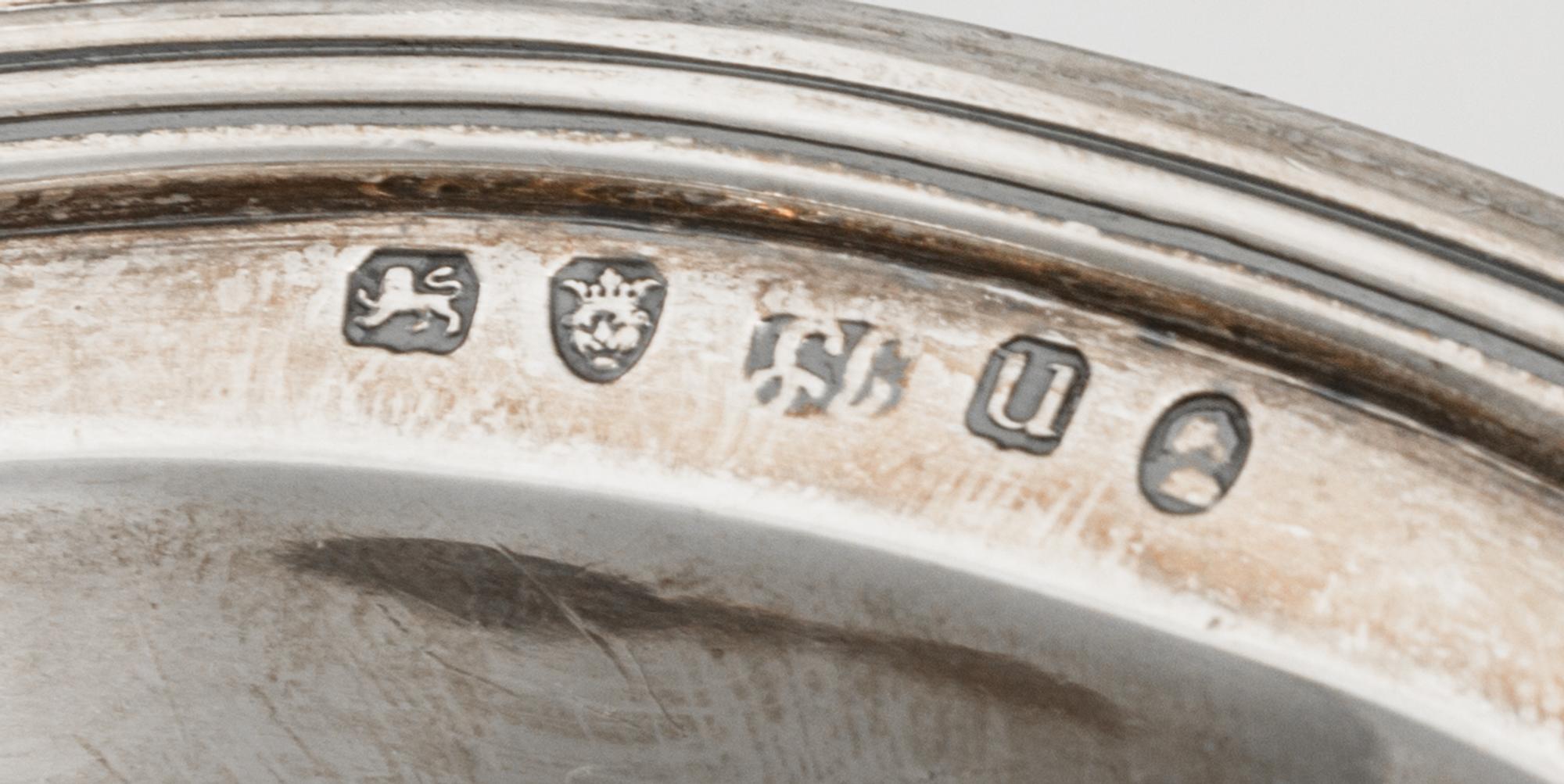 A George III Silver Basket, Joseph Scammell, London, 1795, oval form with reeded sides and swing handle, center engraved with arms.
