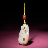 A Chinese Russet and White Jade Reticulated 'Lotus' Pendant, 18th/19th Century — 清中期 白玉帶皮鏤雕蓮紋佩