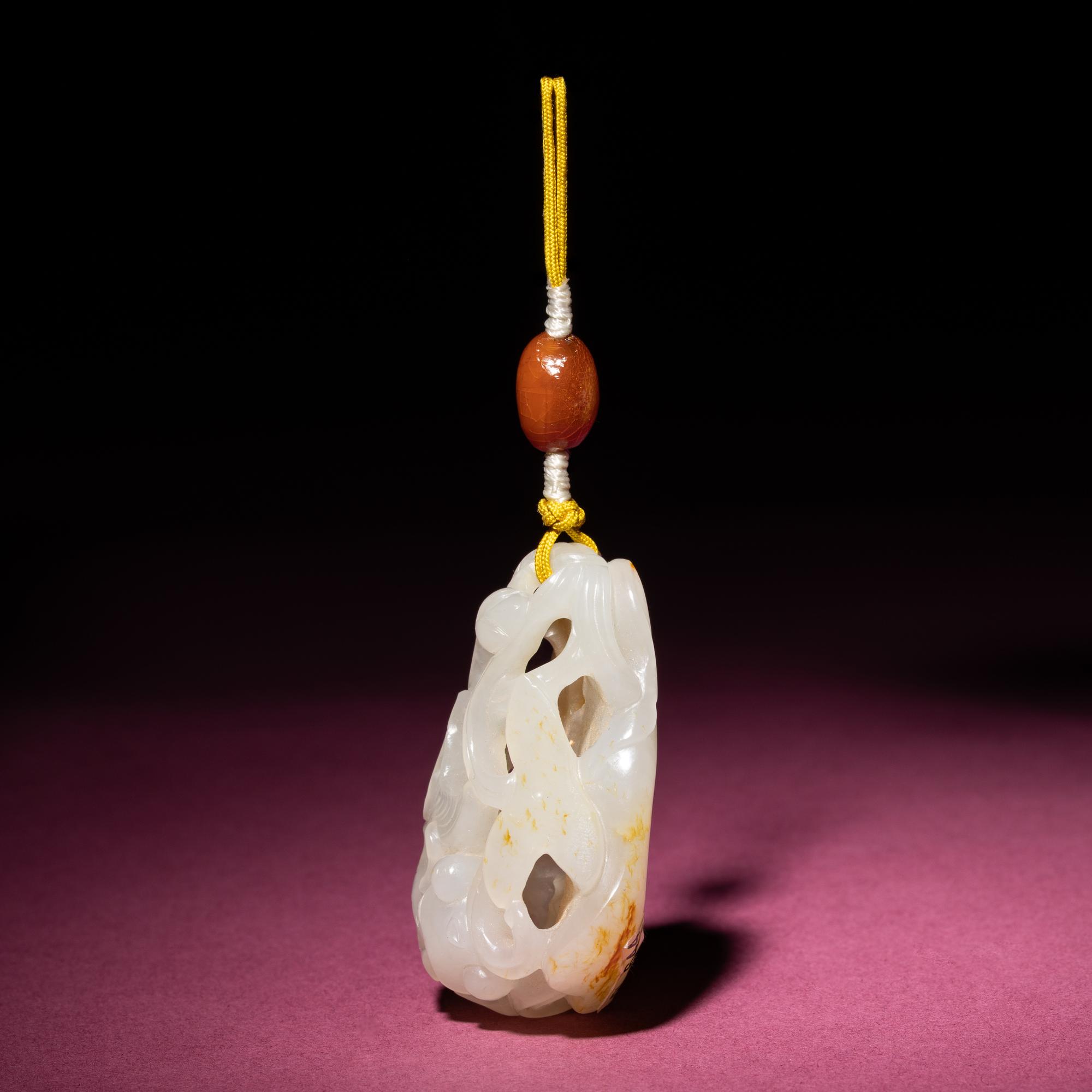 A Chinese Russet and White Jade Reticulated 'Lotus' Pendant, 18th/19th Century — 清中期 白玉帶皮鏤雕蓮紋佩