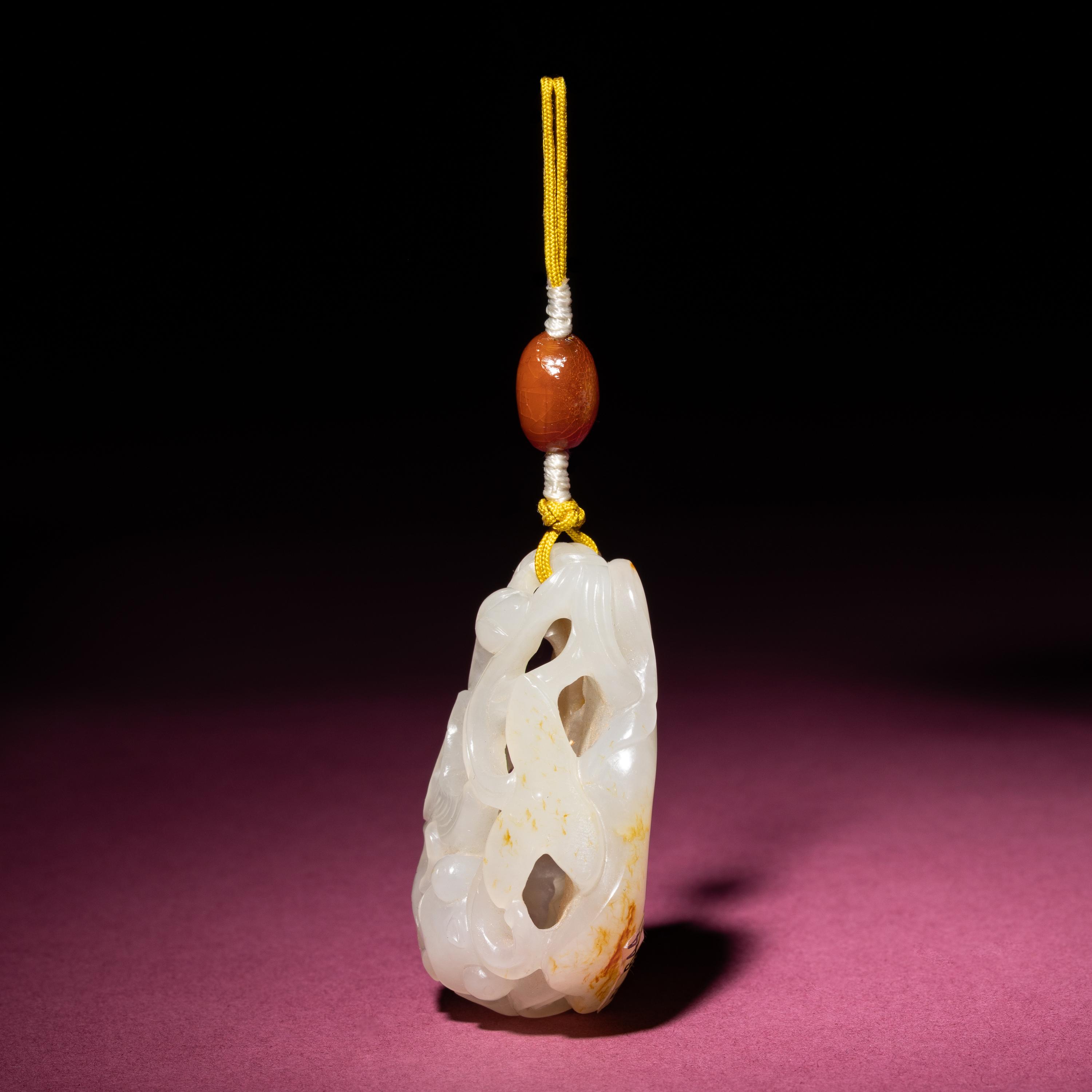 A Chinese Russet and White Jade Reticulated 'Lotus' Pendant, 18th/19th Century — 清中期 白玉帶皮鏤雕蓮紋佩