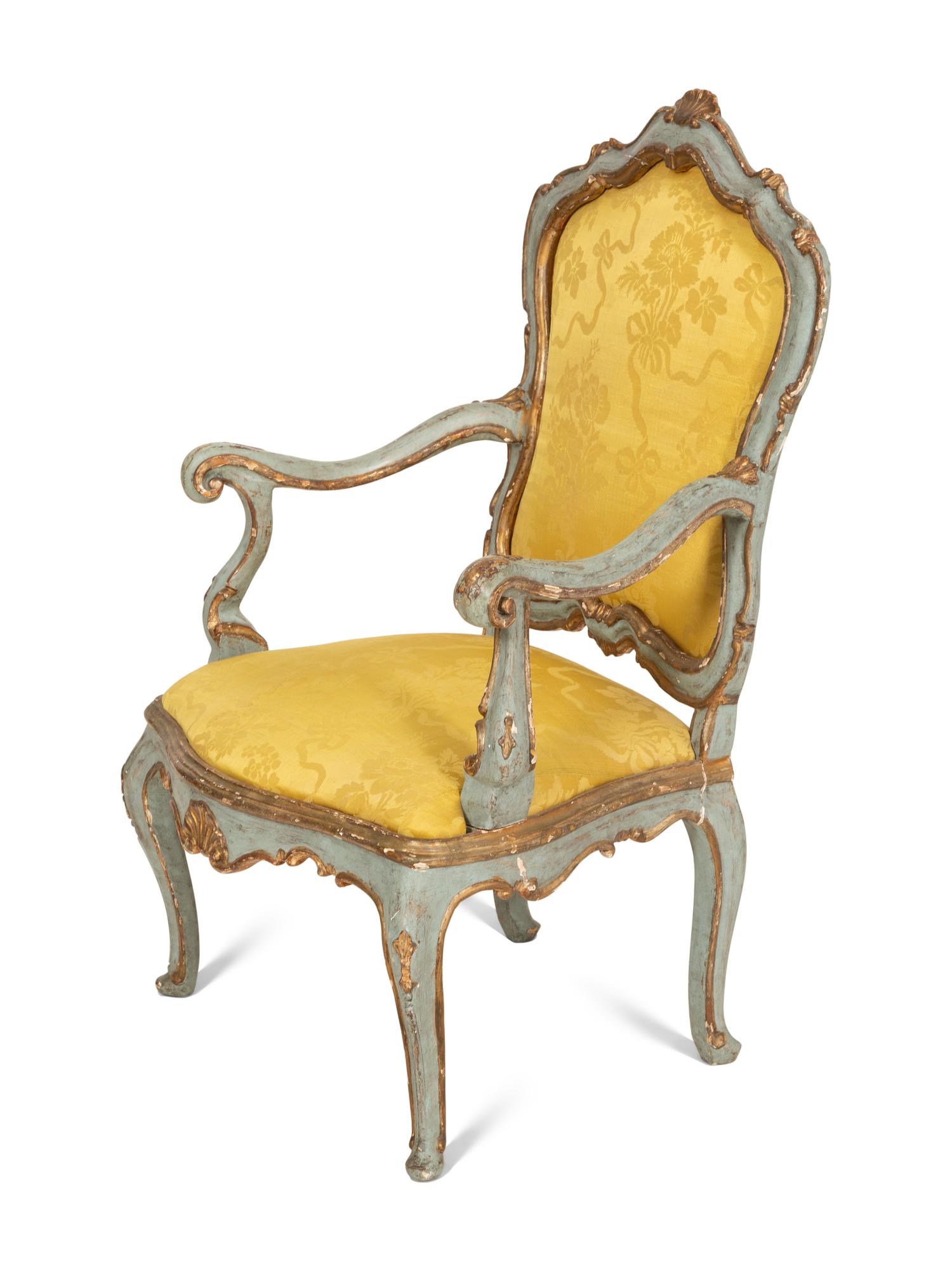 An Italian Rococo Painted and Parcel Gilt Open Armchair