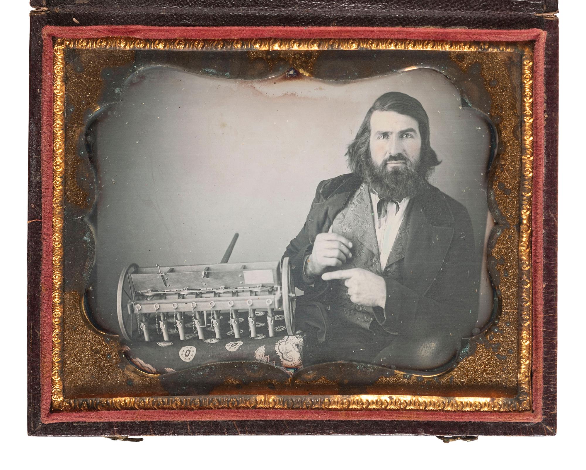 [EARLY PHOTOGRAPHY]. Quarter plate daguerreotype featuring a likely inventor posed with a model of a seed drill.