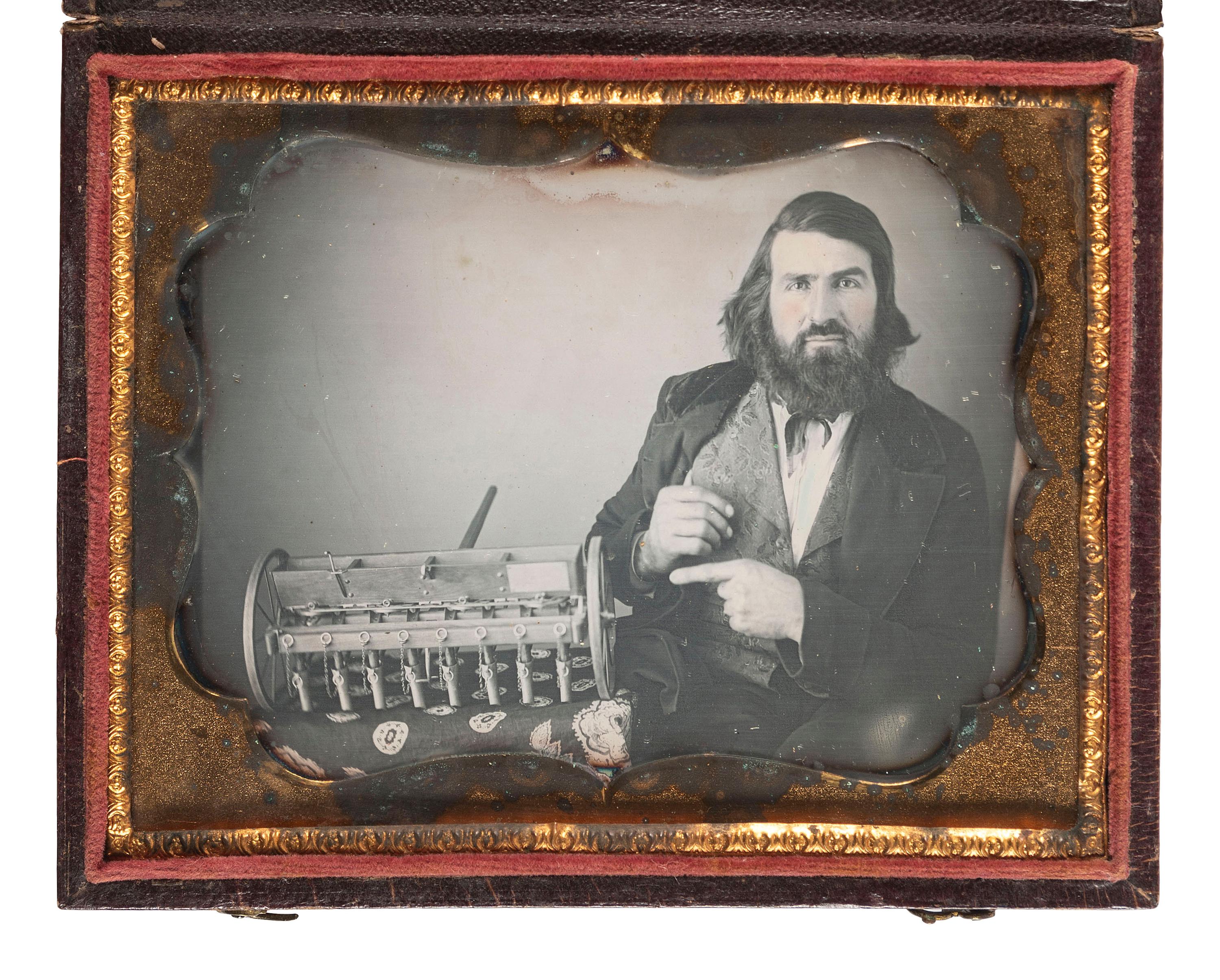 [EARLY PHOTOGRAPHY]. Quarter plate daguerreotype featuring a likely inventor posed with a model of a seed drill.