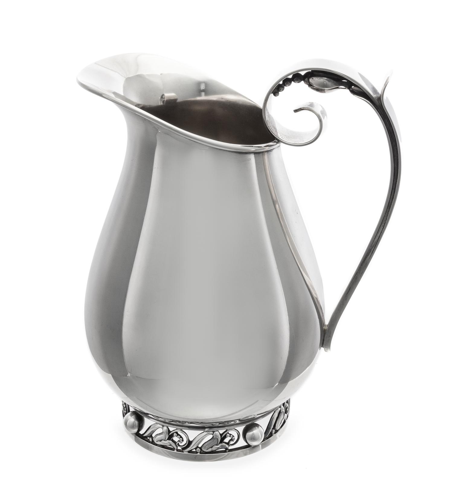 An American Silver Water Pitcher, Alphonse LaPaglia for International Silver Co., Meriden, CT, Mid-20th Century, the scrolled handle wi