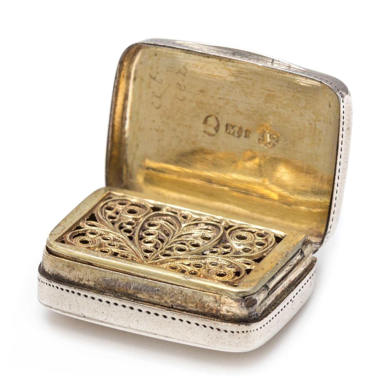 A George III Silver Vinaigrette, Matthew Linwood, Birmingham, 1810, the lid decorated with foliate and stippled decoration centered by
