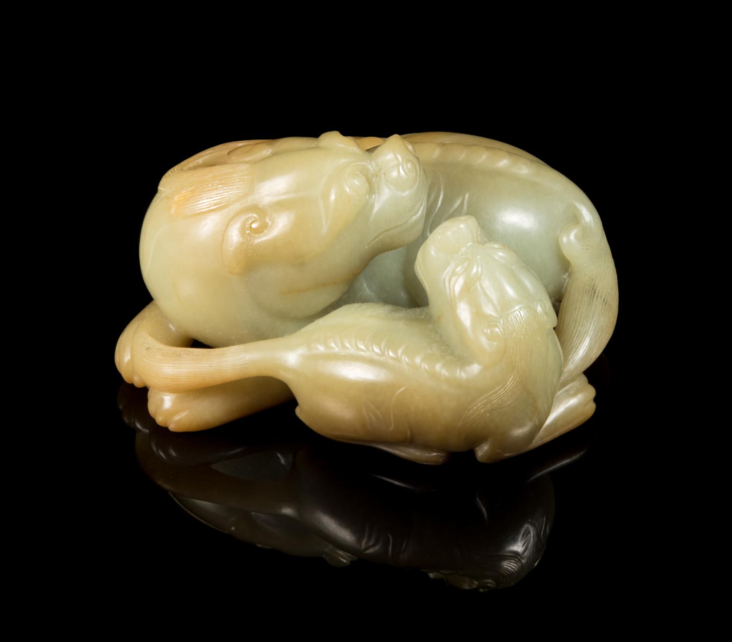 A Chinese Celadon and Russet Jade Carving of Two Mythical Beasts Length 3 3/4 inches. — 20TH CENTURY